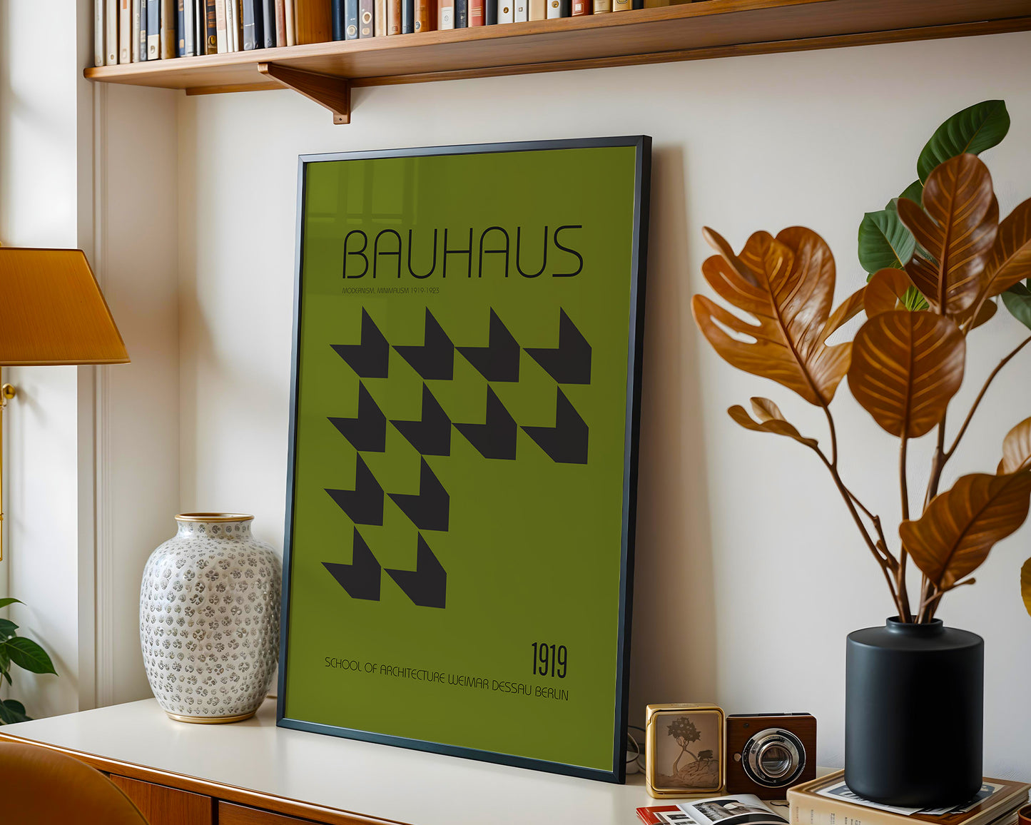 Framed Bauhaus poster on a shelf with decorative items