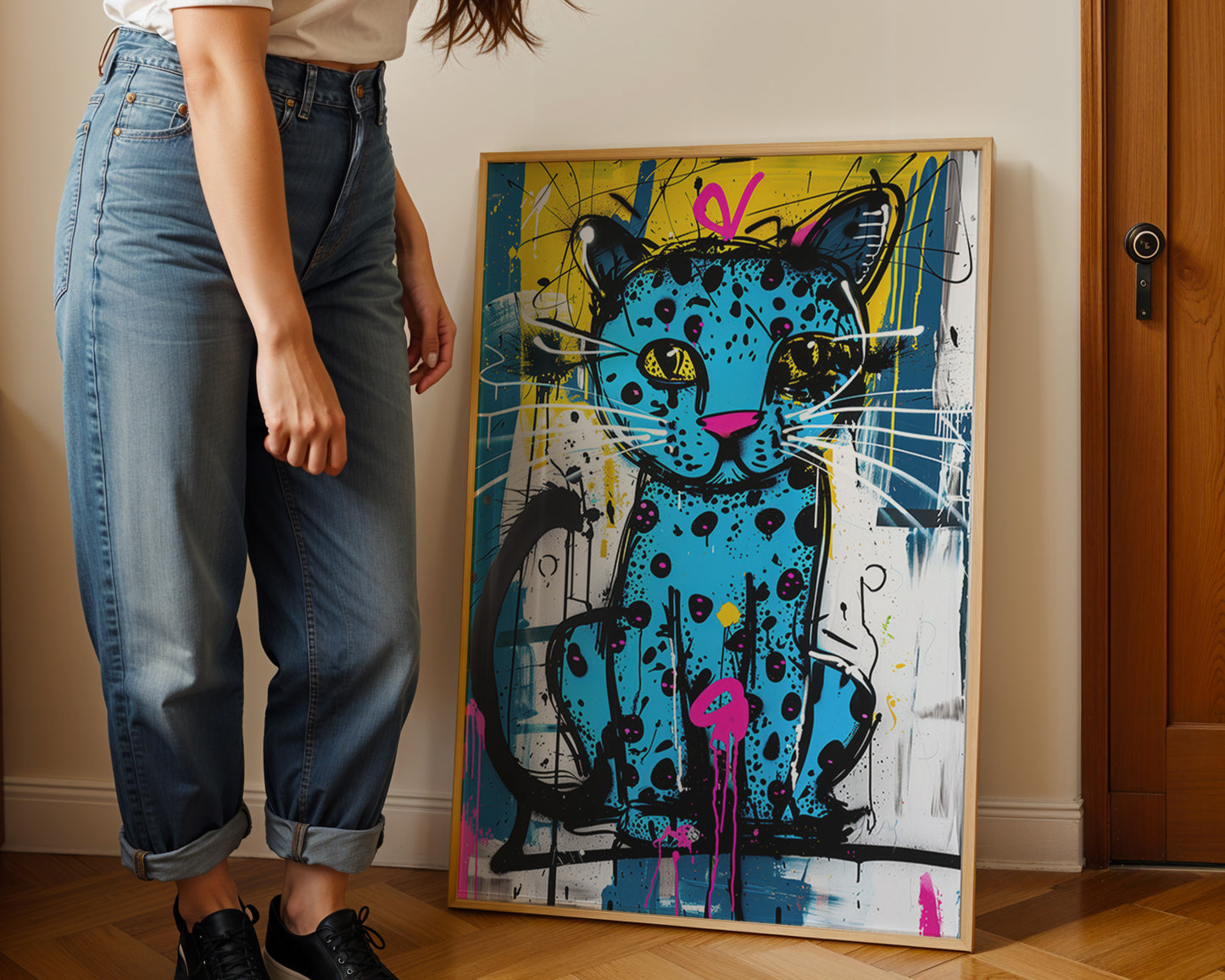 Person standing next to ablue leopard art print abstract painting of a cat on a wall.