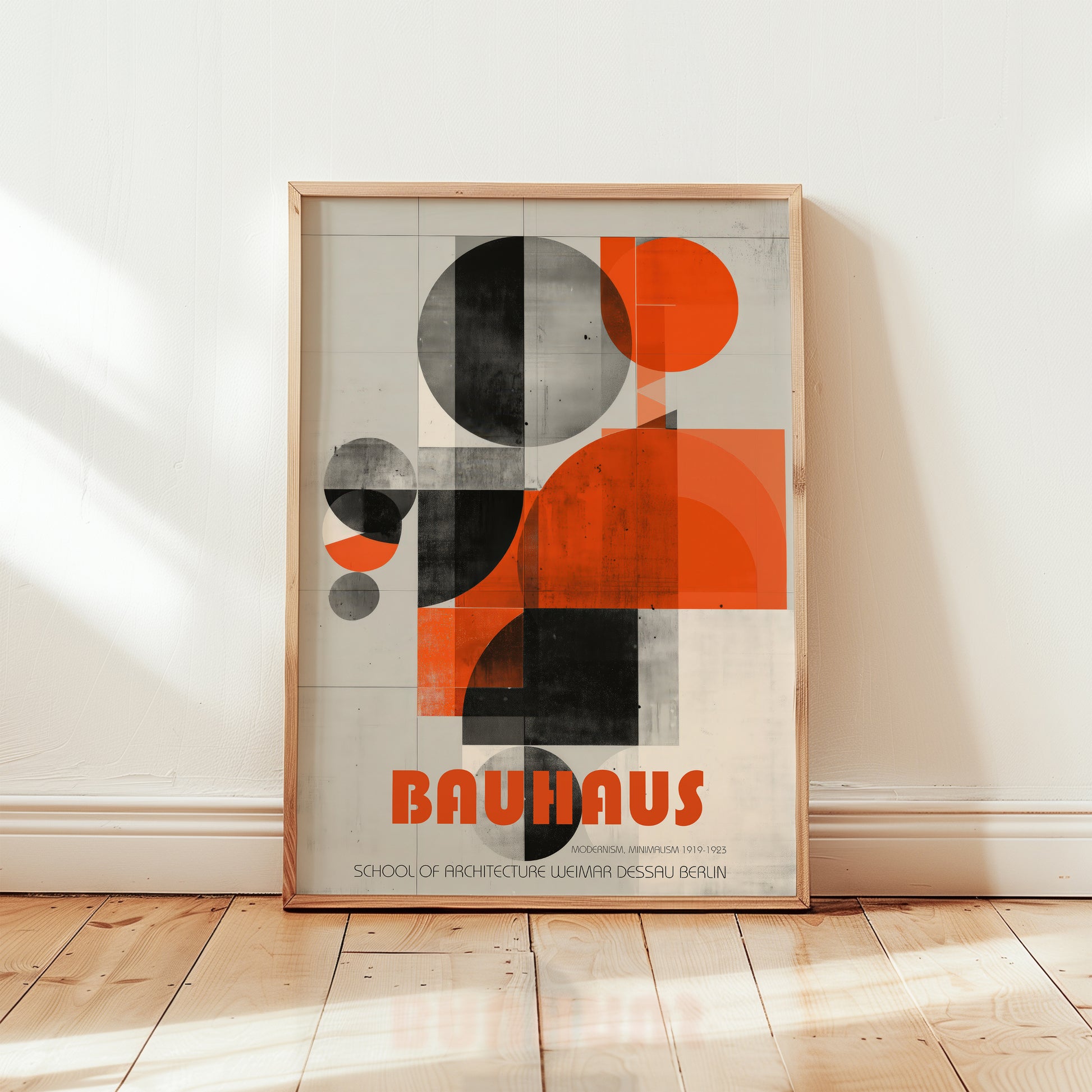 Framed Bauhaus poster on a wall with geometric design and 'Bauhaus' text.
