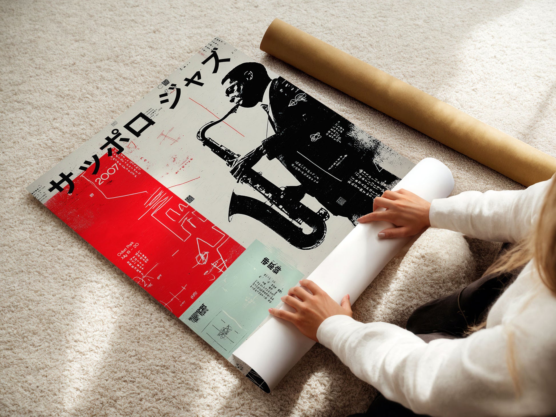 Person unrolling a large poster with a saxophone design on a light-colored floor.