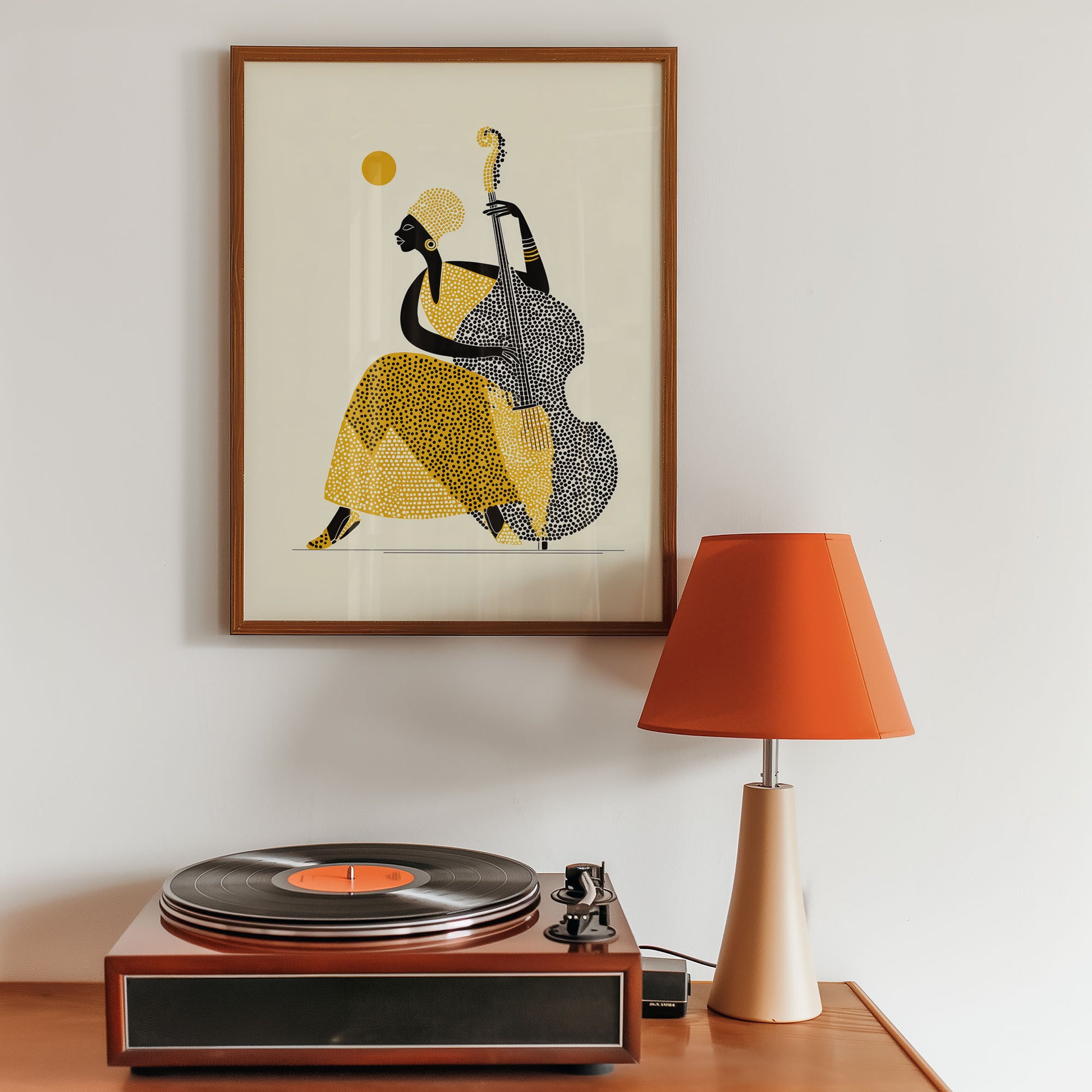 Framed artwork of a person playing a double bass above a record player with an orange lamp.