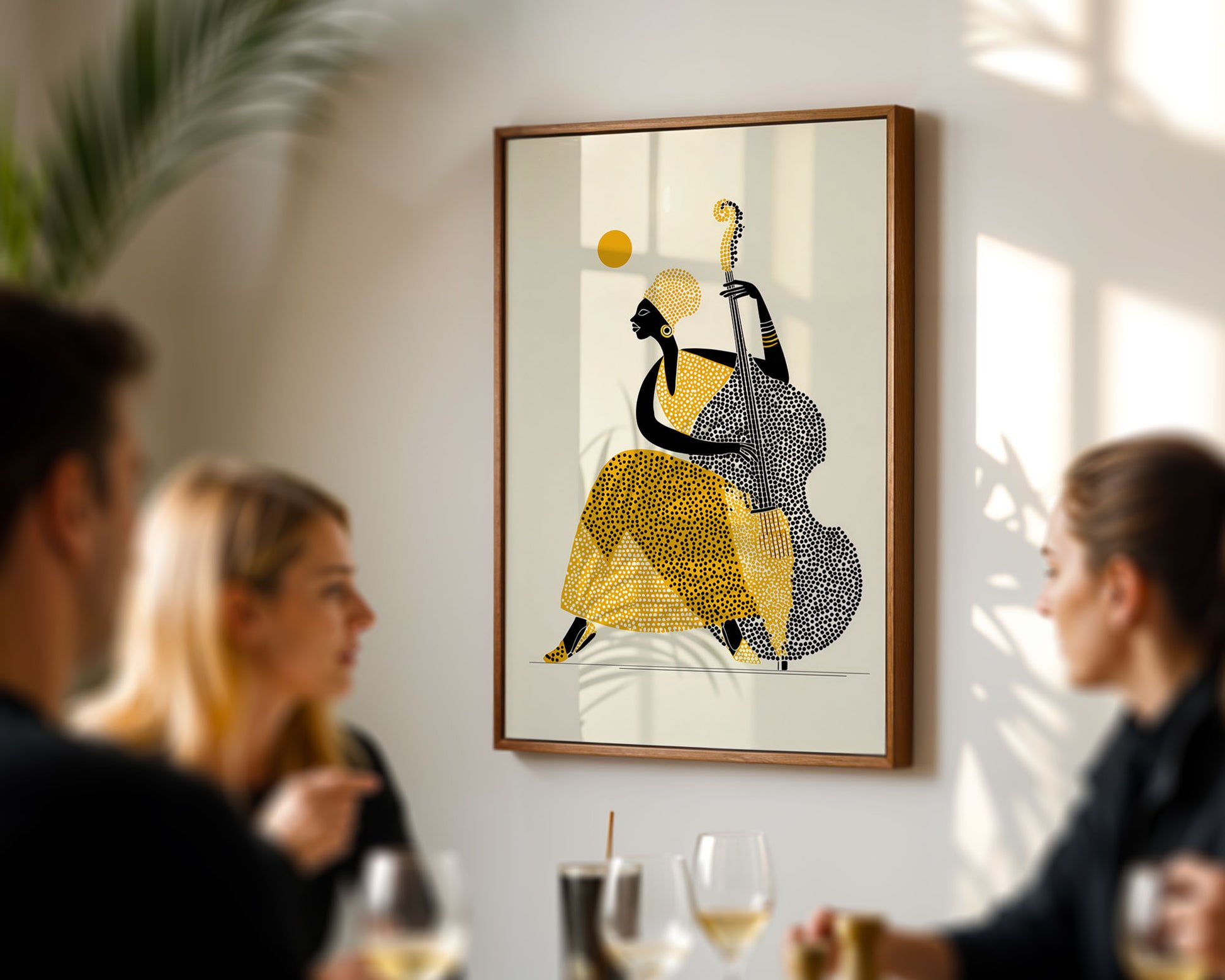 Framed artwork of a stylized figure in a yellow dress and black top on a wall with people socializing below.