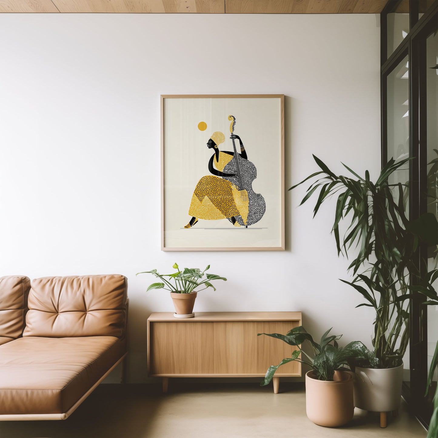 Modern living room with a tan sofa, wooden cabinet, and framed abstract art on a white wall.