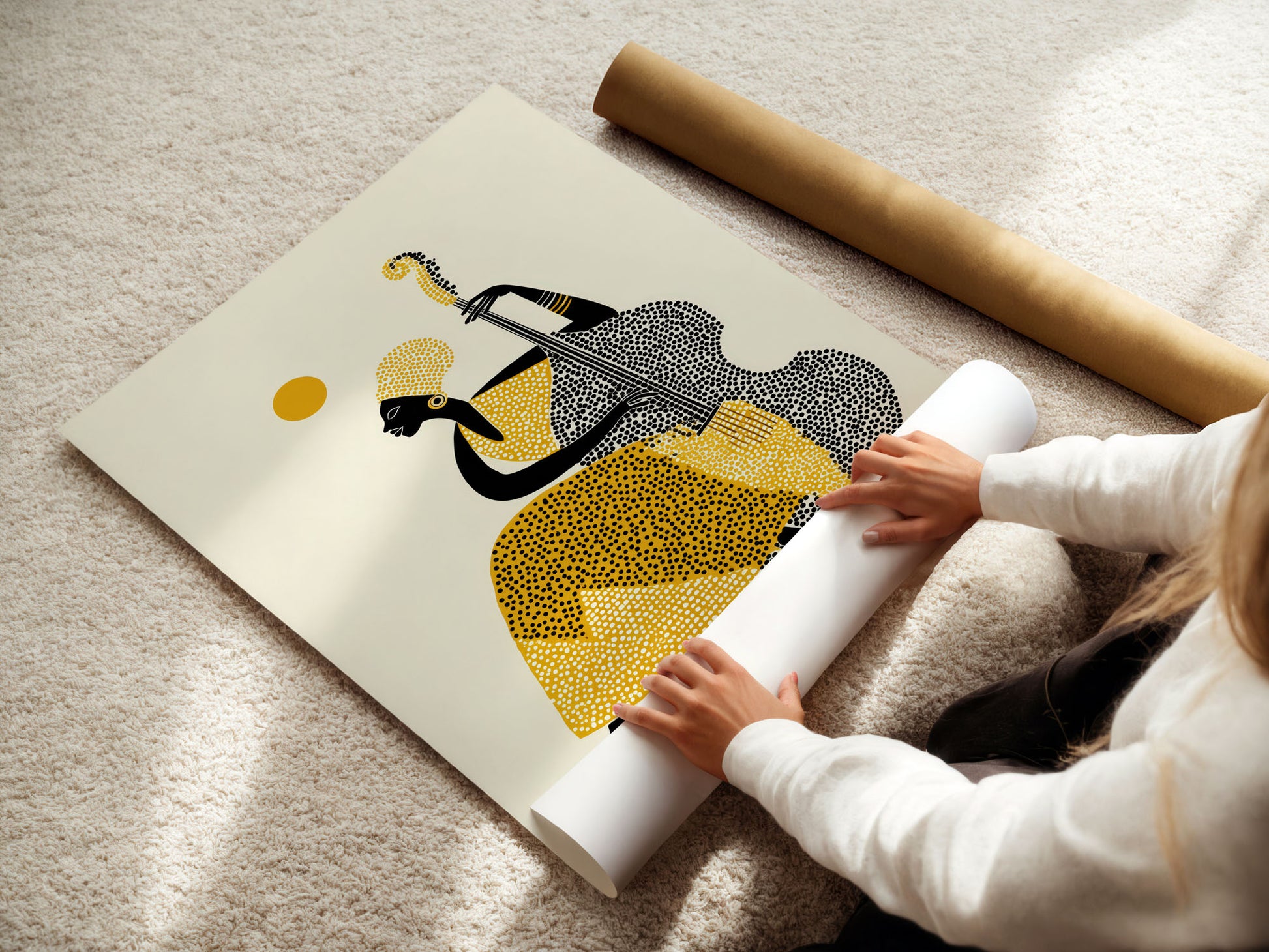 Person unrolling a large abstract art print on a light-colored floor.
