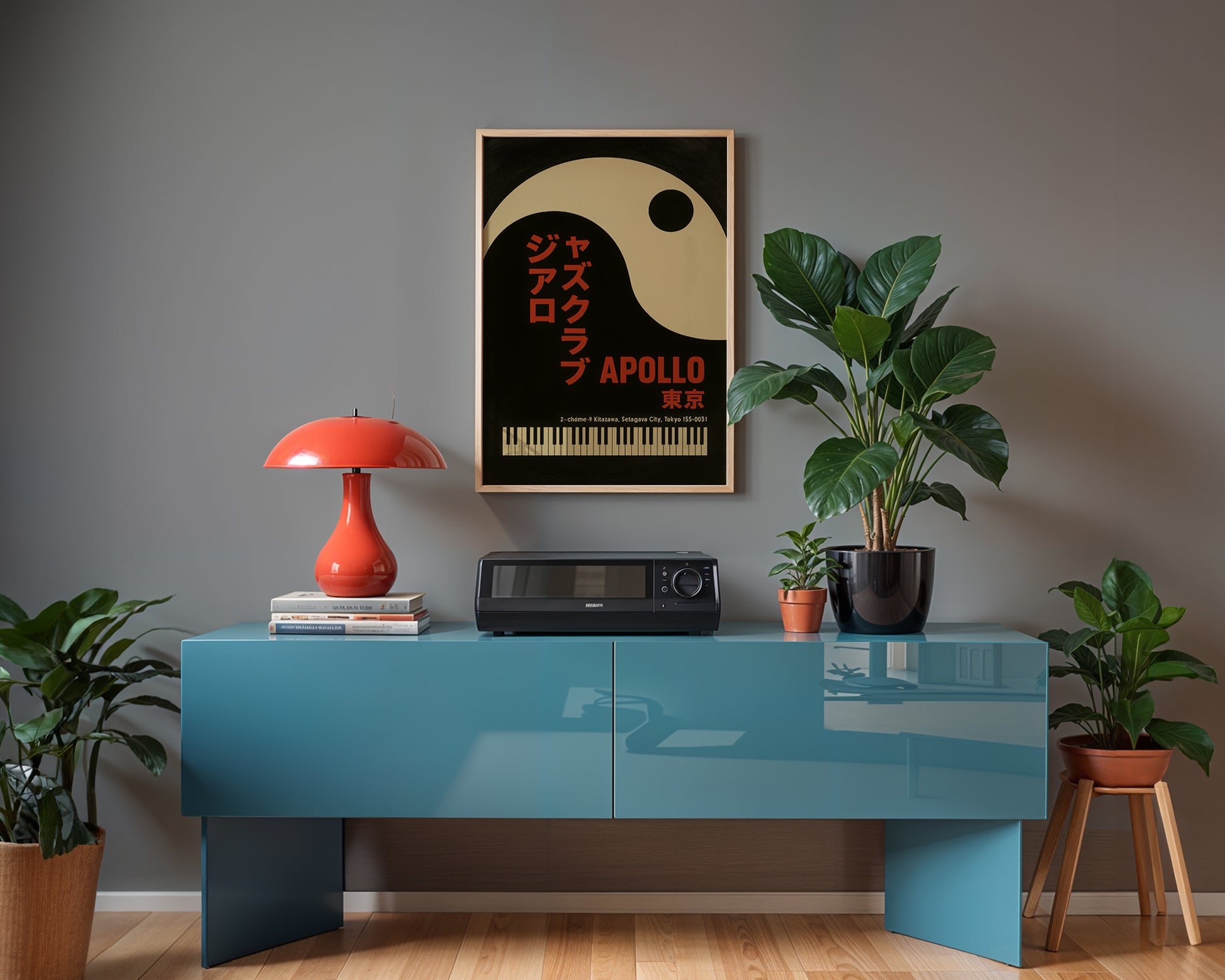 Modern interior with a blue console table, red lamp, and framed poster on a gray wall.