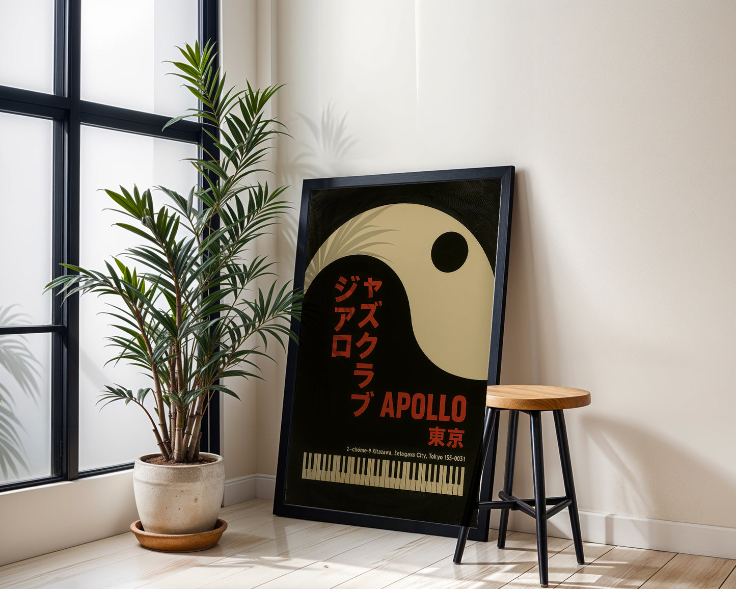 Framed poster with 'Apollo' design next to a plant and stool in a room.