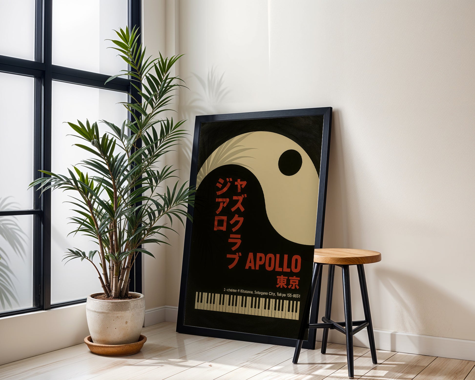 Framed poster with 'Apollo' design next to a plant and stool in a room.