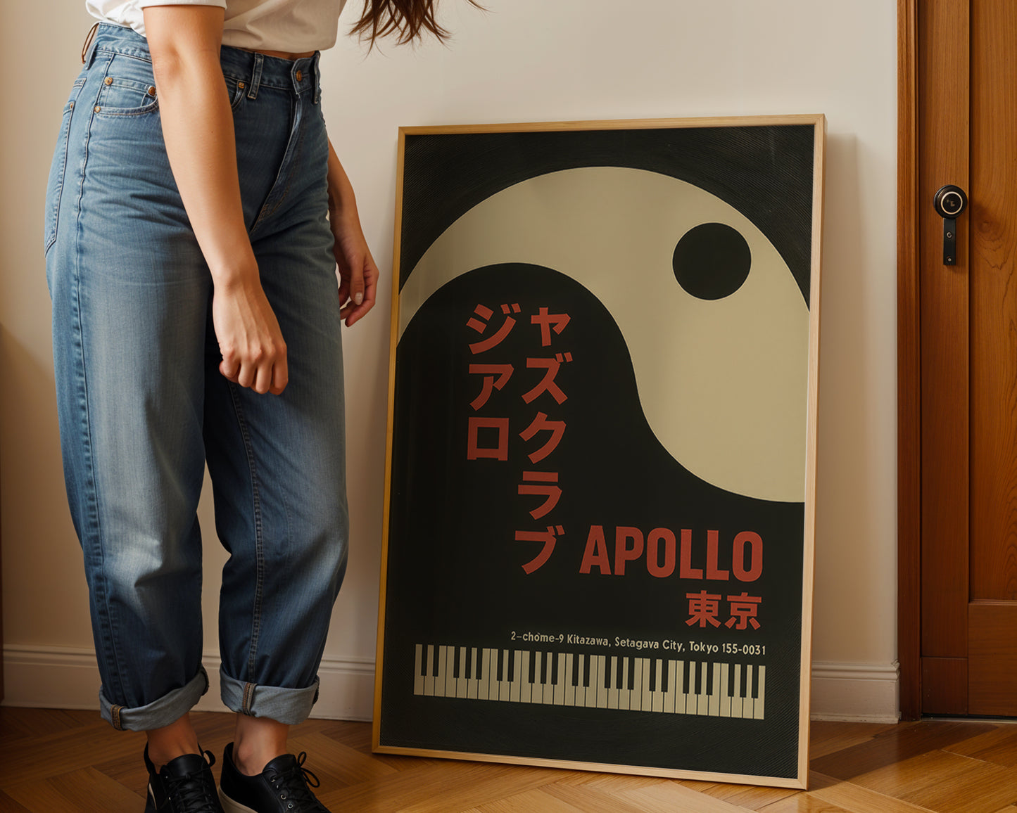 Person standing next to a framed poster of the Apollo Jazz Club in Tokyo