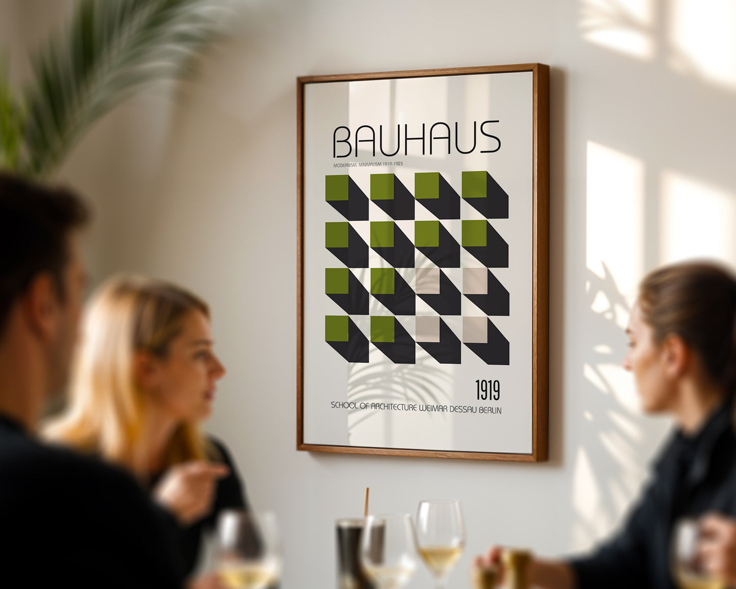 Framed Bauhaus poster on a wall with people in the foreground