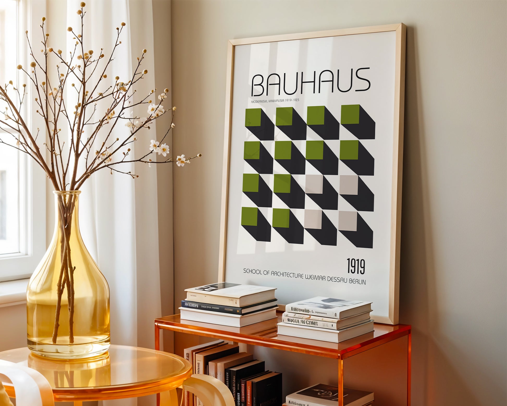 Framed Bauhaus poster on a shelf with books and a vase in a  mid-Century style room. 