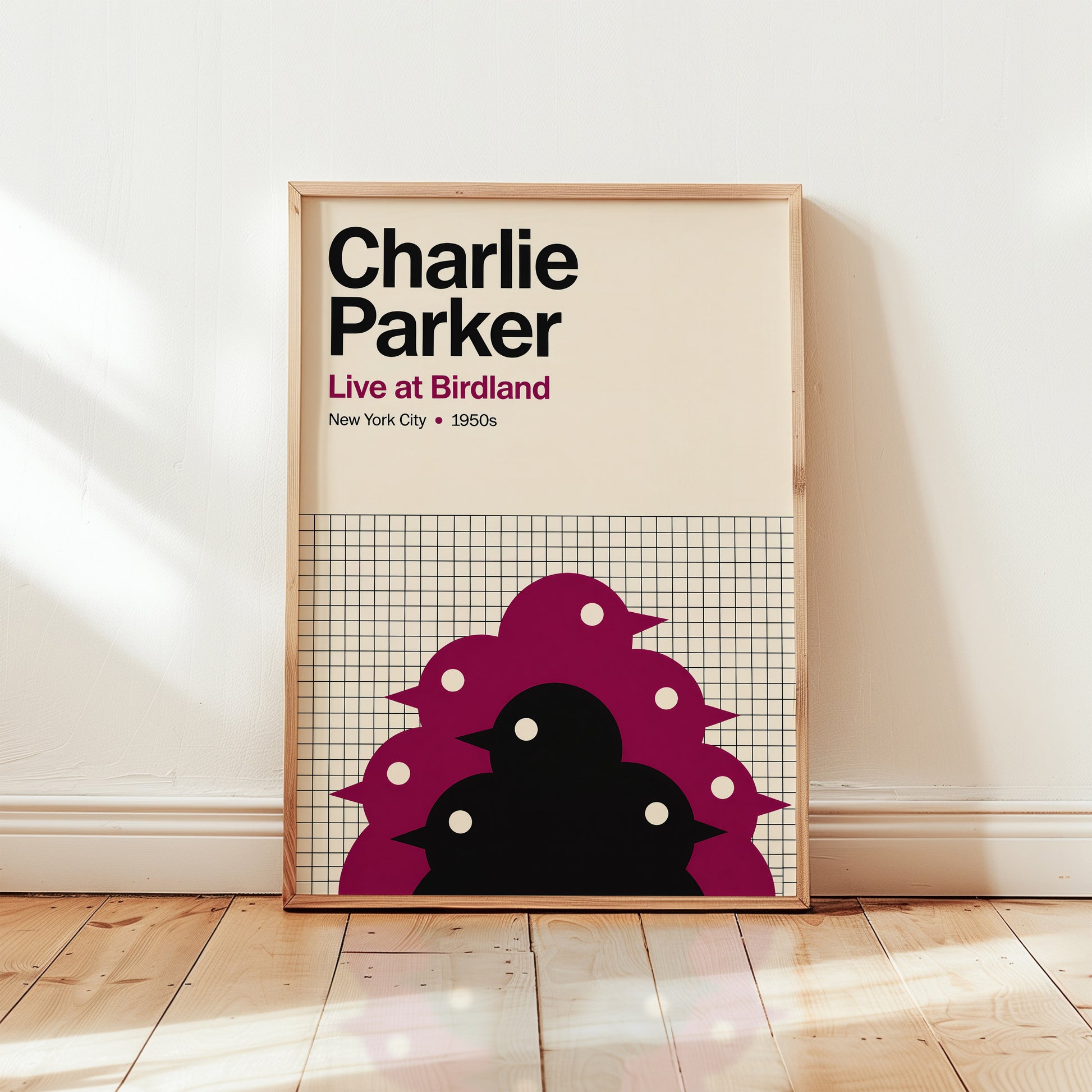 Framed poster of Charlie Parker with a design of birds on a grid background, placed on a wooden floor.