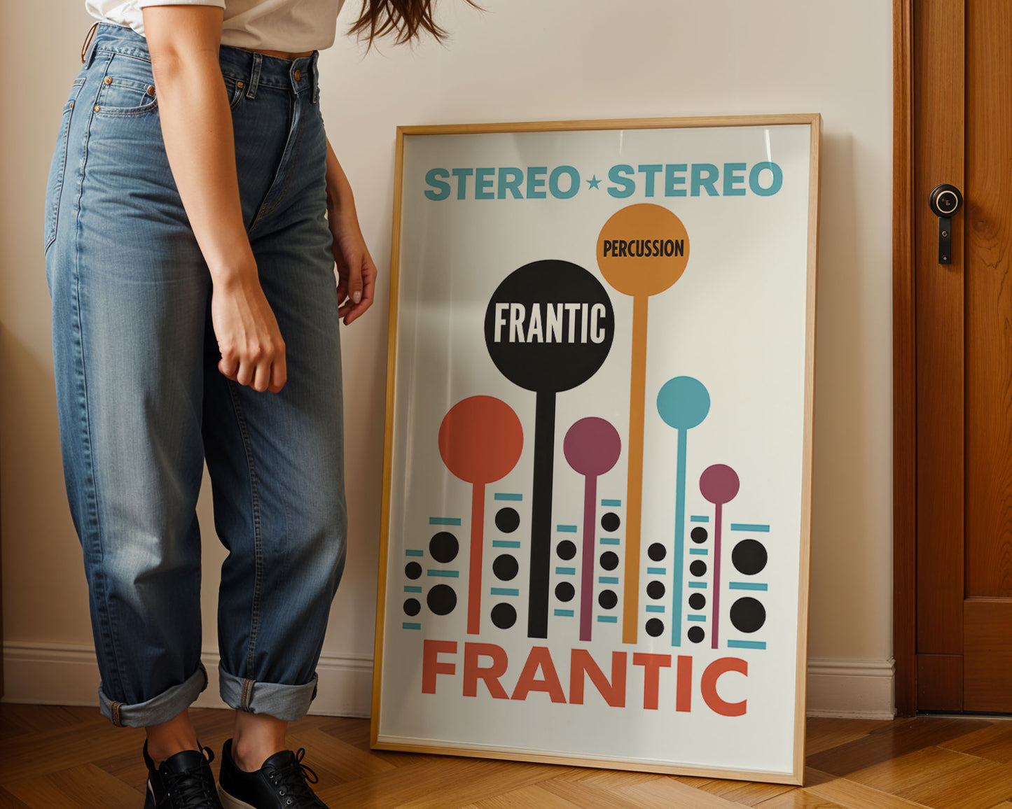 Person standing next to a framed poster with 'Stereo Stereo' and 'Frantic' text.