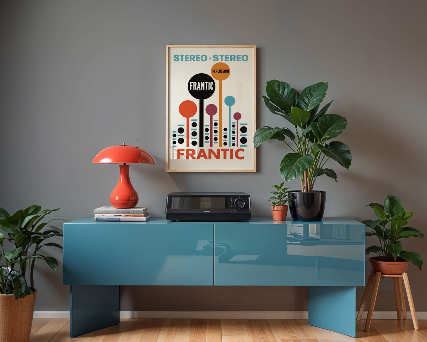 Modern interior with a blue console table, red lamp, and framed poster on a gray wall.