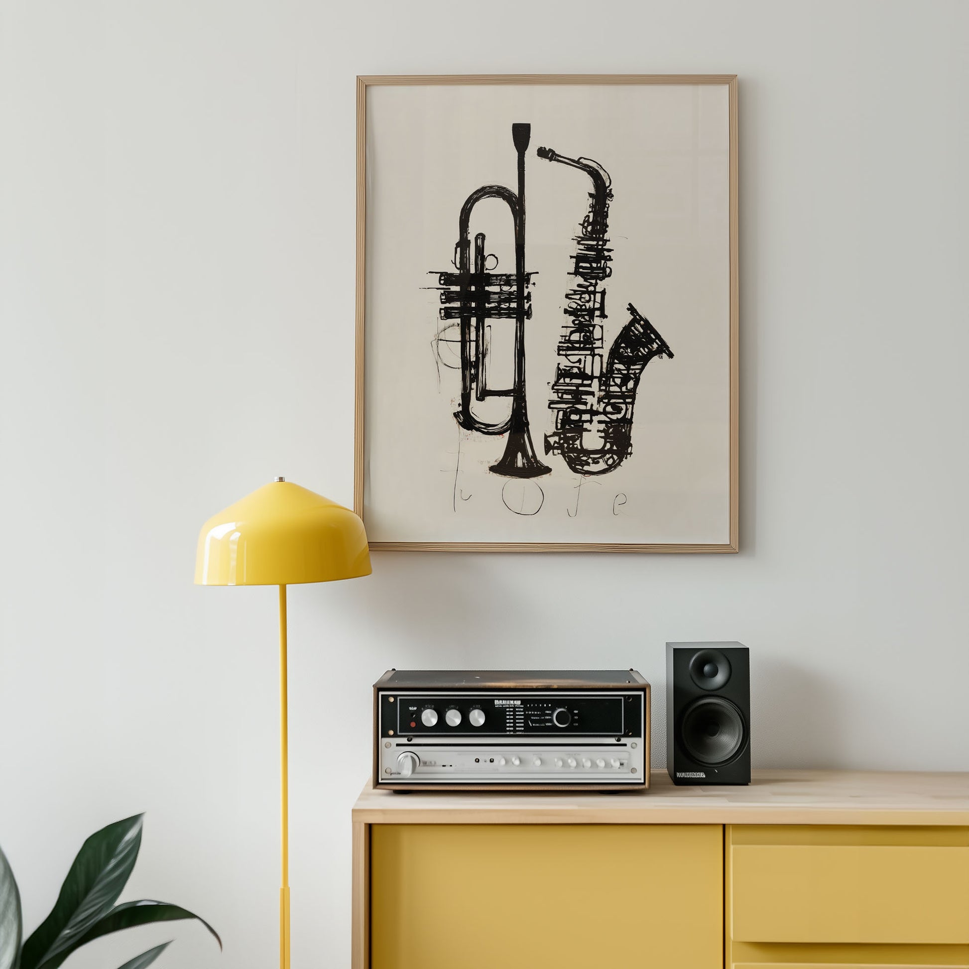 Framed artwork of a saxophone and trumpet on a wall above a yellow cabinet with stereo equipment.