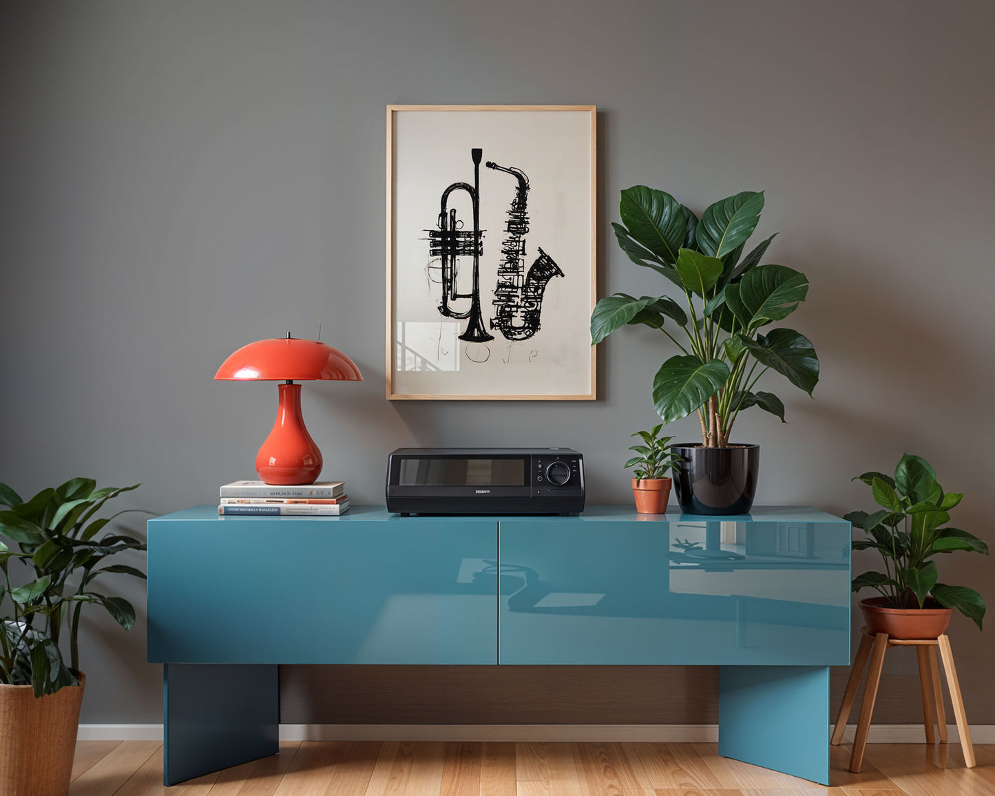 Modern interior with a blue console table, red lamp, and framed artwork on a gray wall.