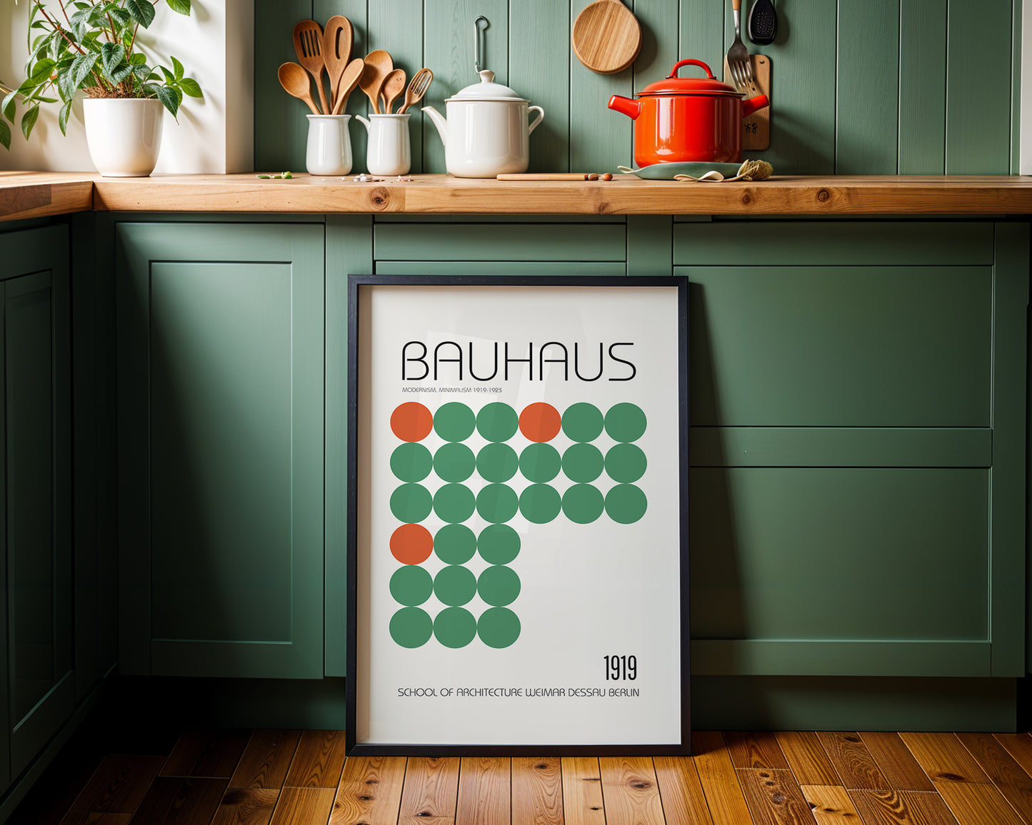Bauhaus poster in a kitchen setting with green cabinets and wooden countertops.