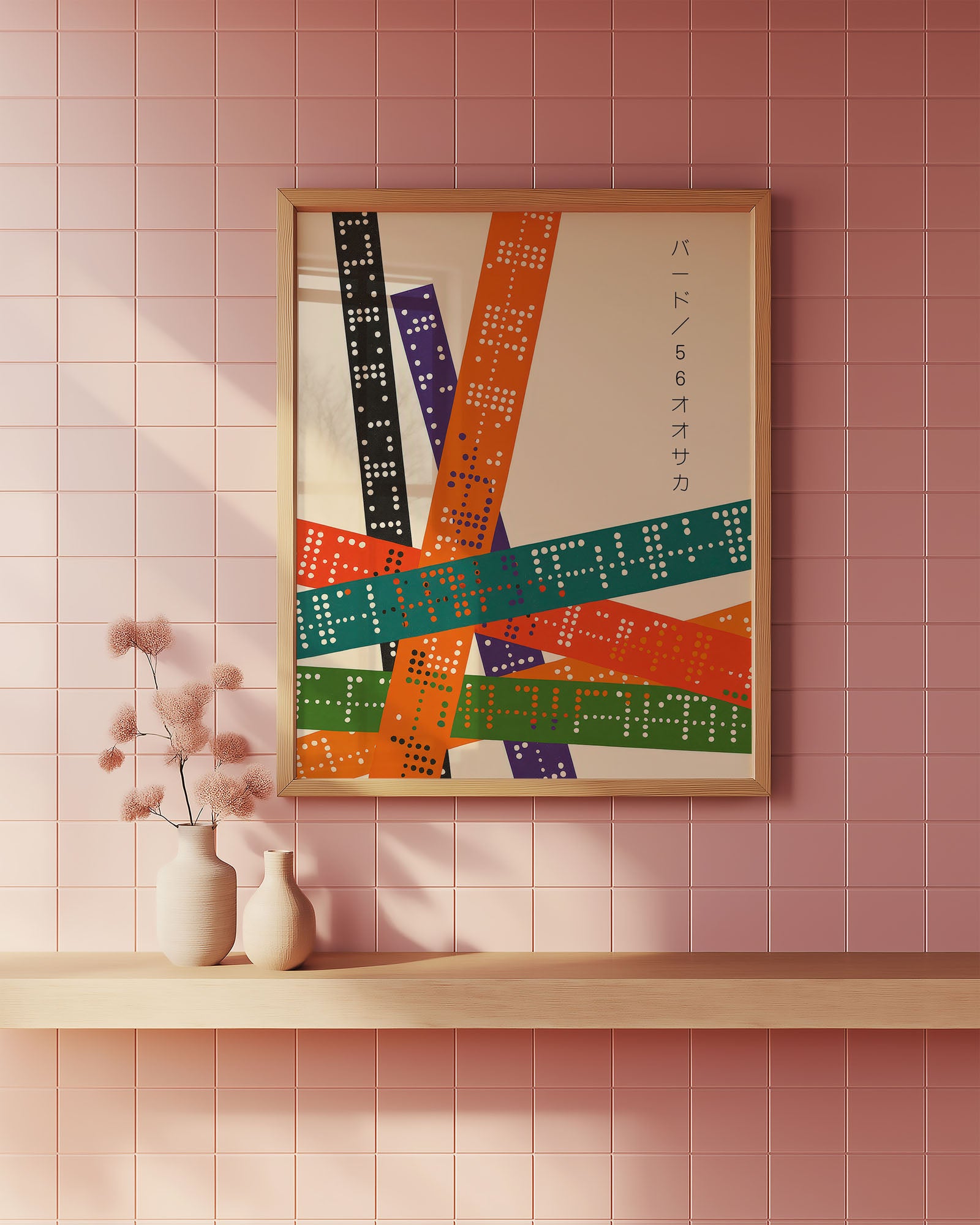 Framed abstract art piece on a pink tiled wall with a shelf and vase.