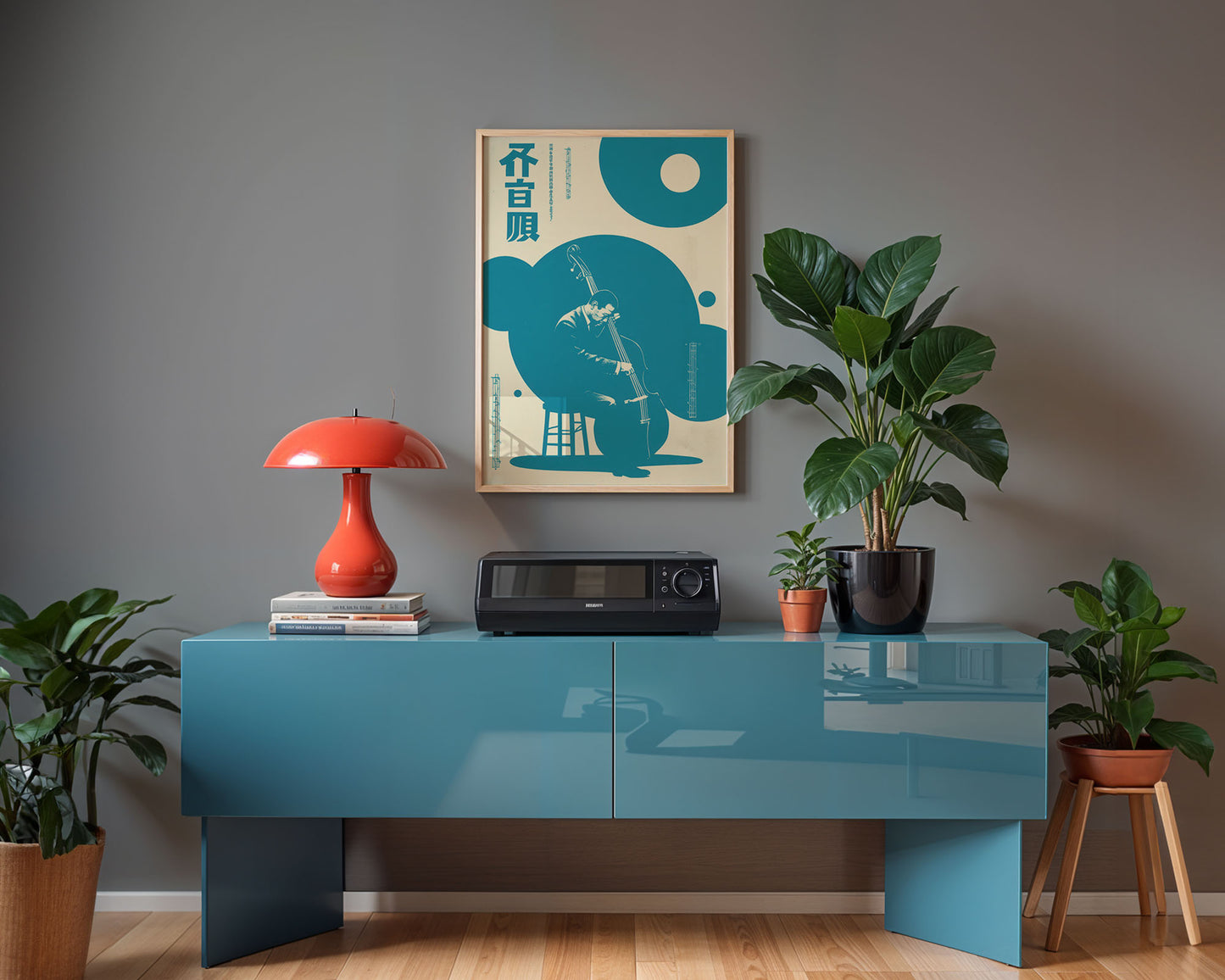 Modern interior with a blue console table, red lamp, and decorative items against a gray wall.