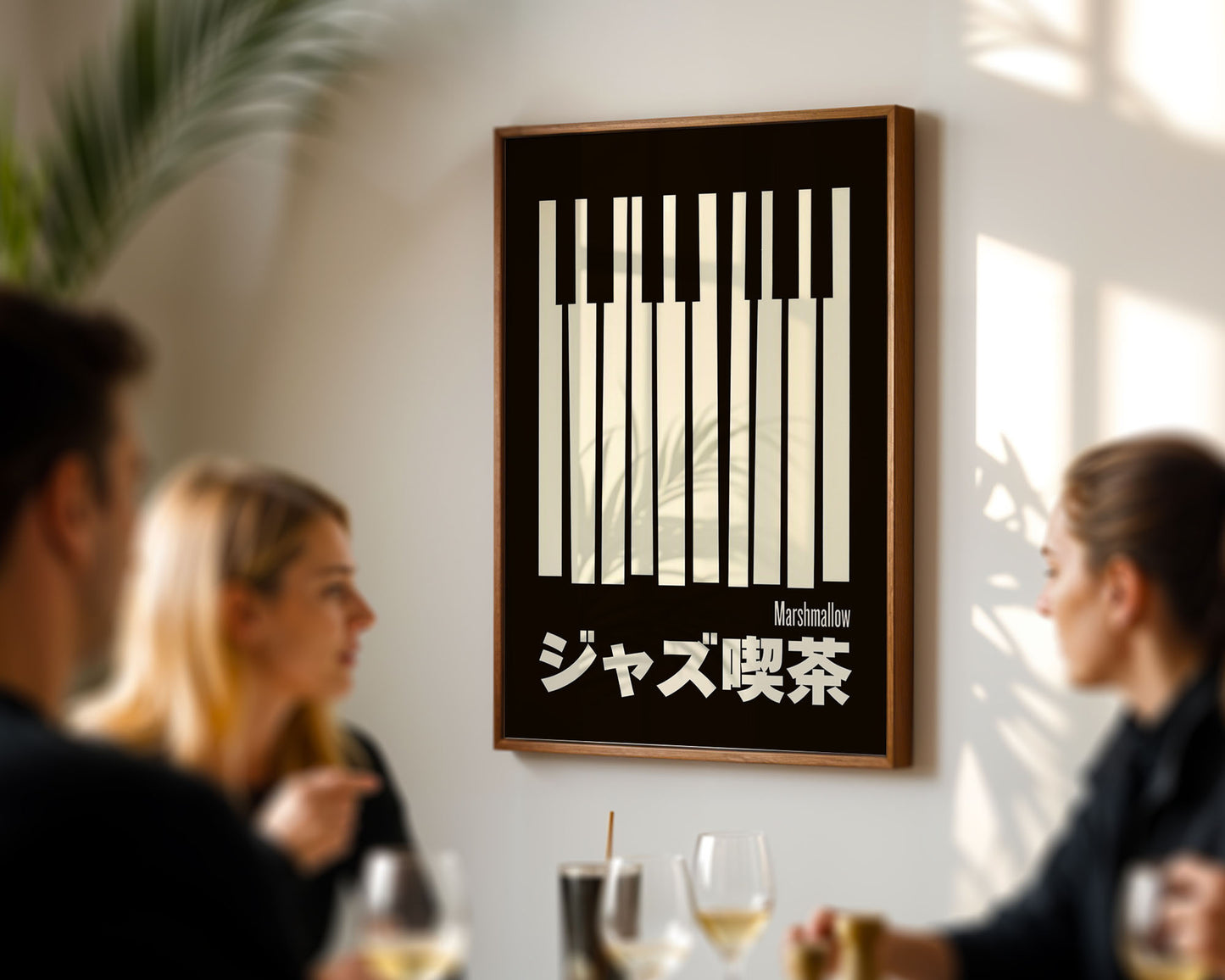 Framed artwork with a black and white design on a wall in a restaurant setting.