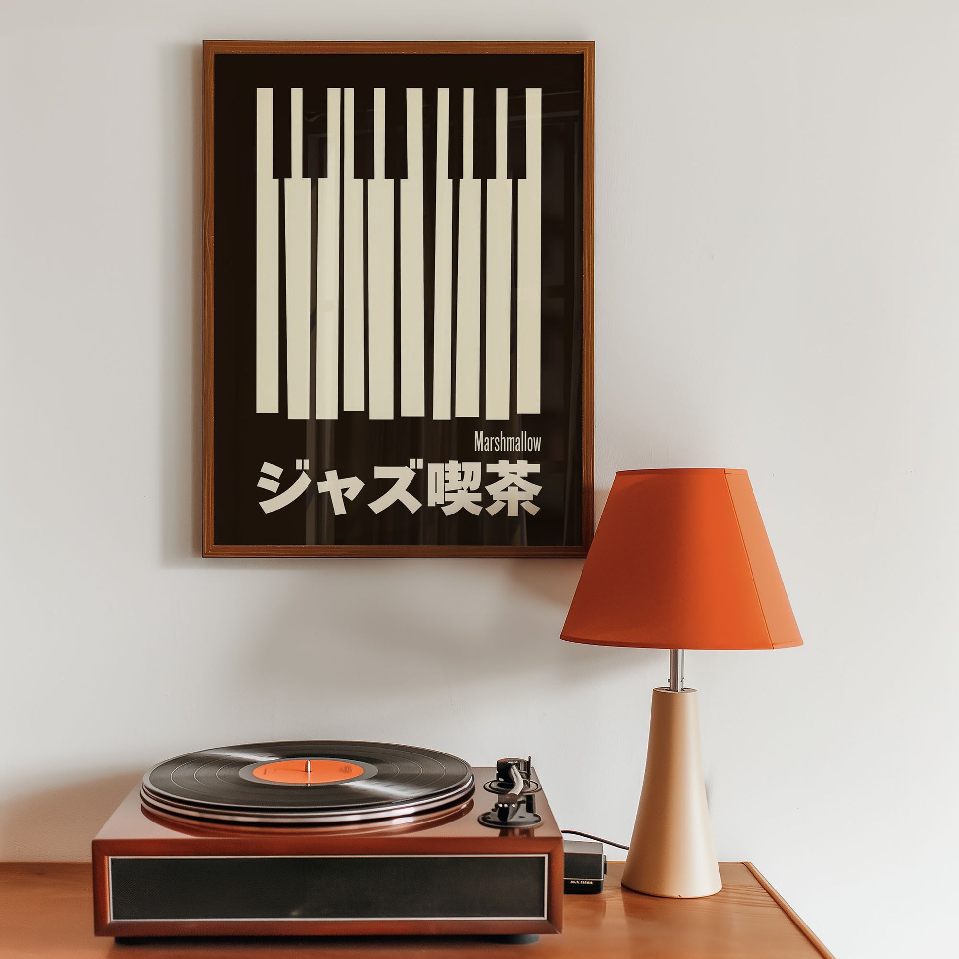 Wooden turntable with vinyl record, framed poster on wall, and orange lamp.