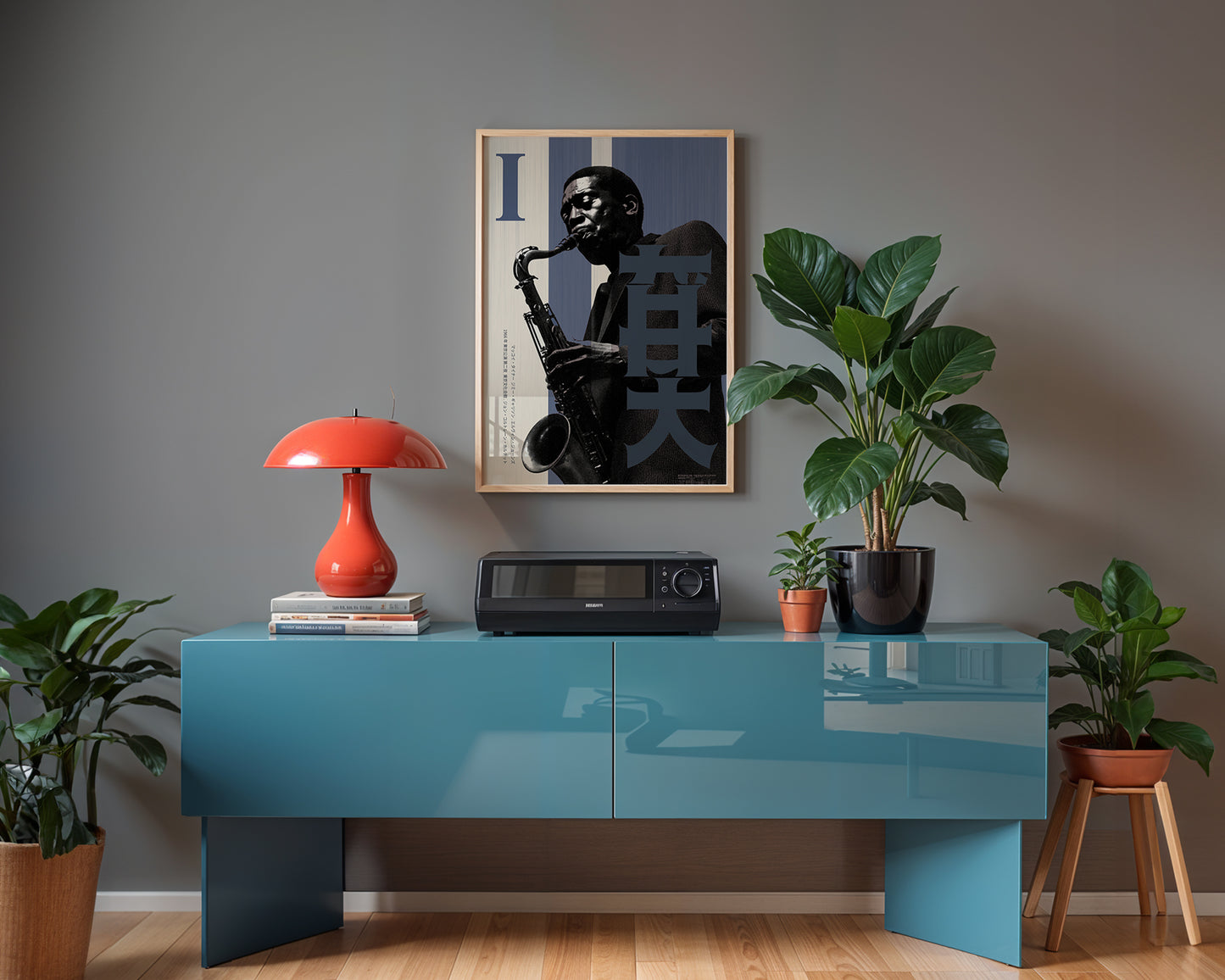 Modern interior with a blue console table, red lamp, and framed artwork on a gray wall.