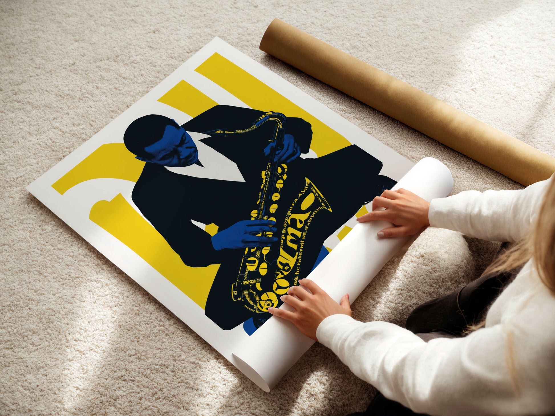 young girl Person unrolling a large poster of a stylized figure with a yellow background on a carpeted floor.
