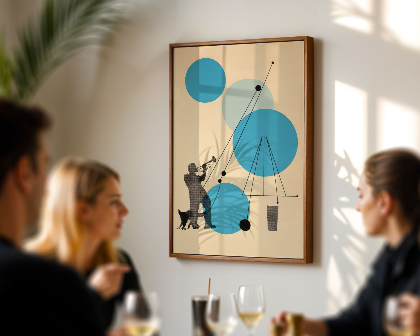 Framed abstract art piece on a wall with people in the foreground.
