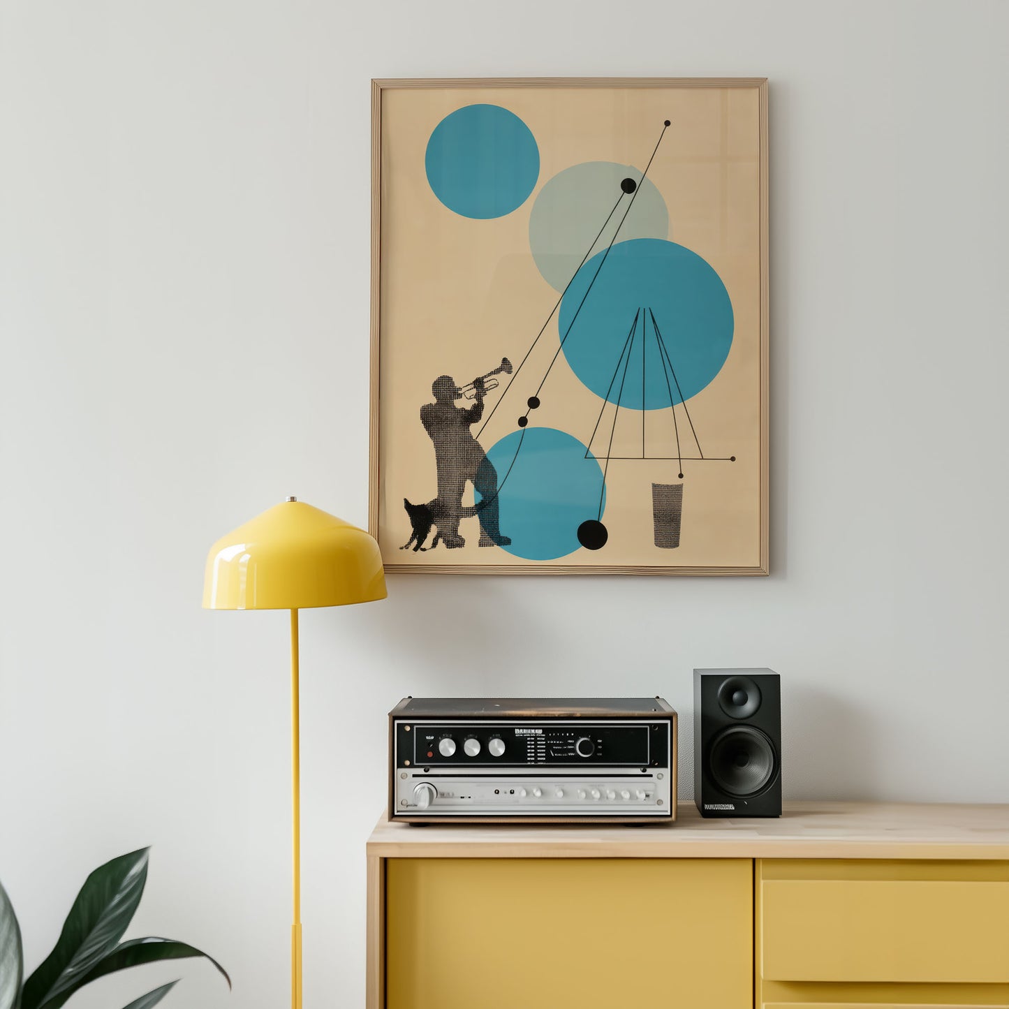 Framed abstract art piece on a wall above a yellow cabinet with stereo equipment.