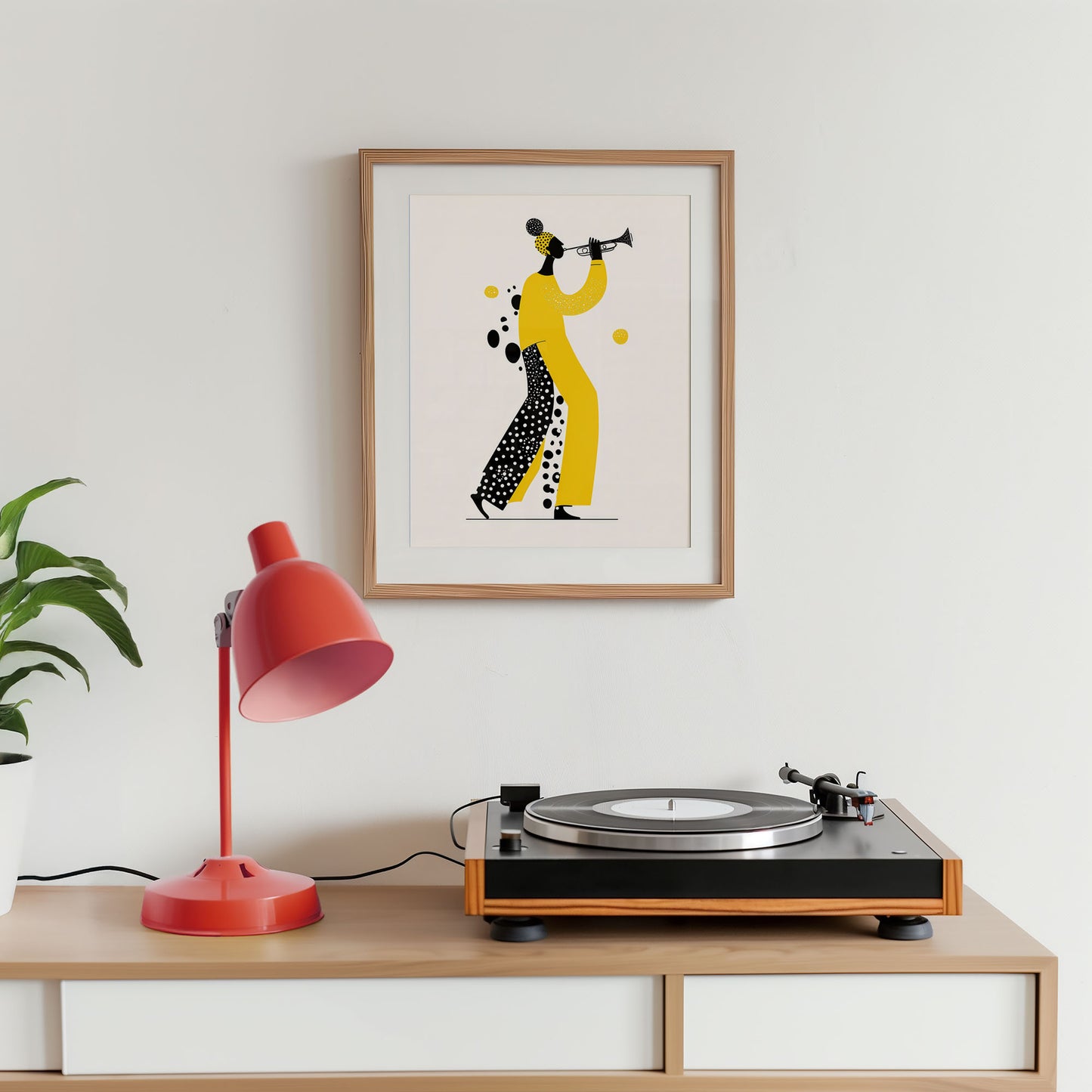 Turntable on a wooden shelf with a framed artwork and a red lamp against a white wall.