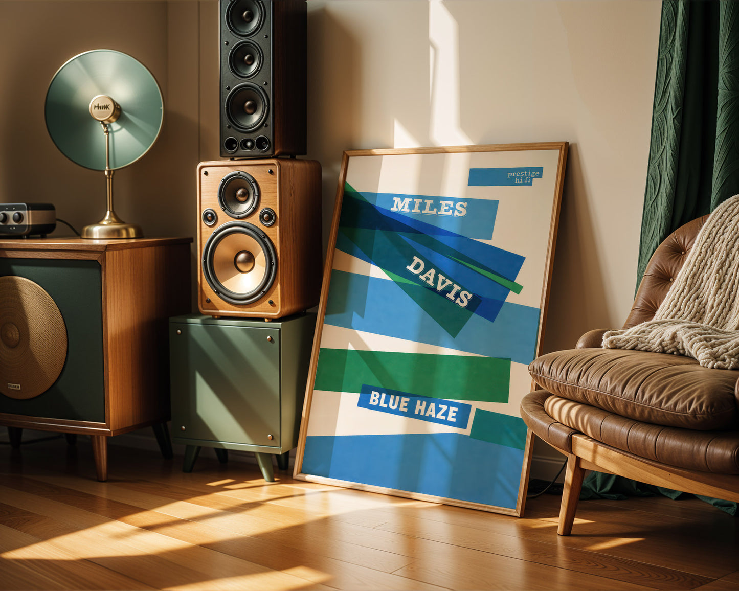Room interior with speakers, a lamp, and a framed Miles Davis 'Blue Haze' poster.