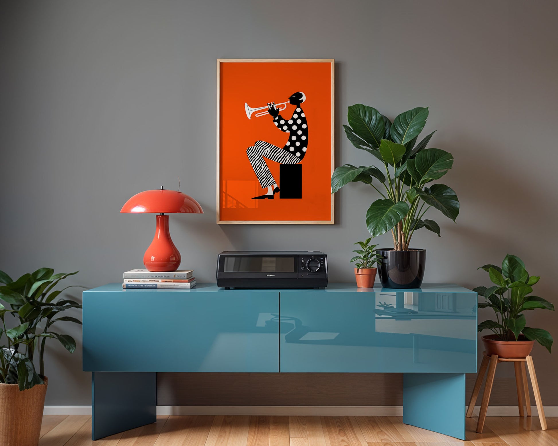 Modern interior with a blue console table, red lamp, and framed artwork on a gray wall.
