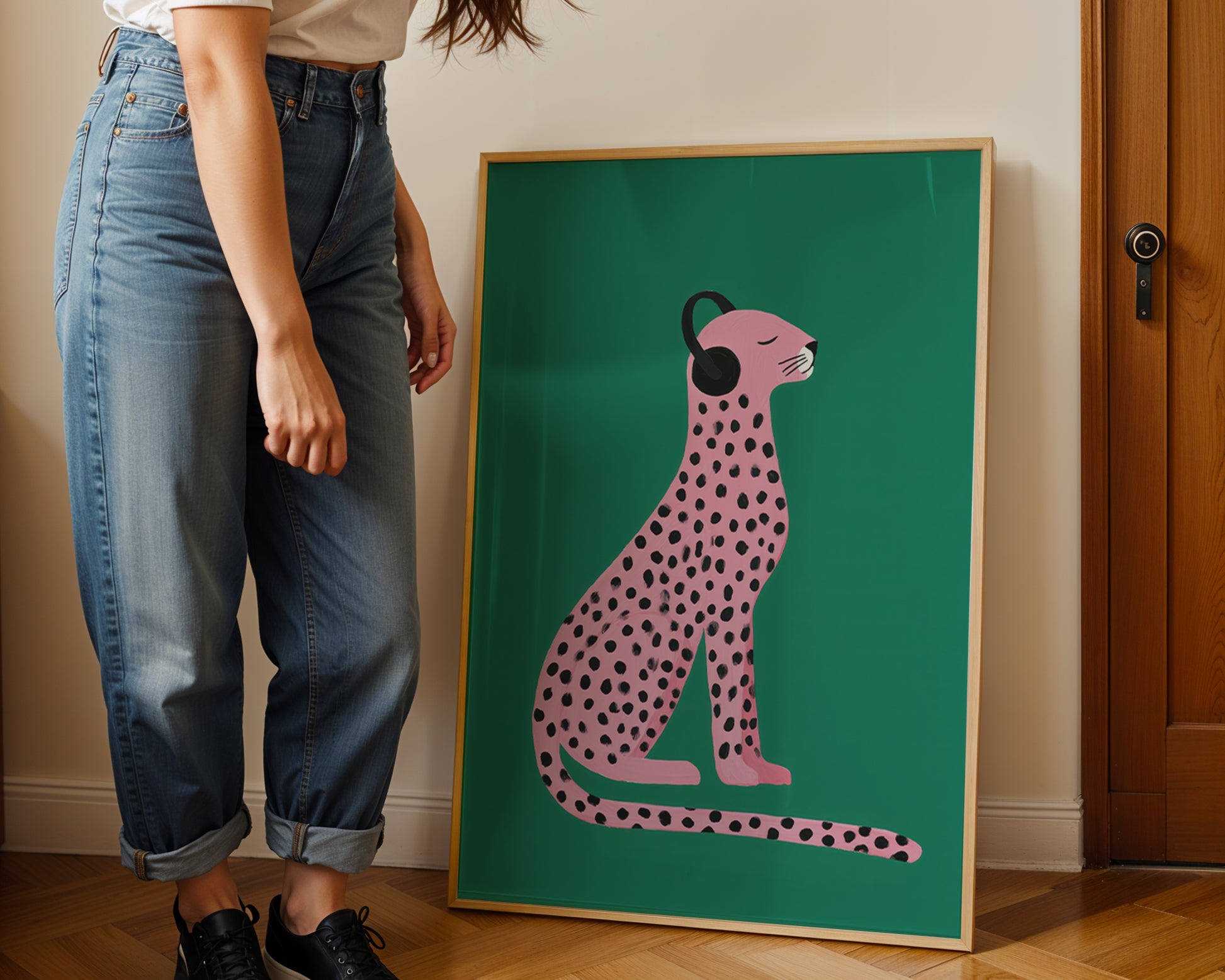Person standing next to afunky wall art illustration of a pink cheetah on a green background