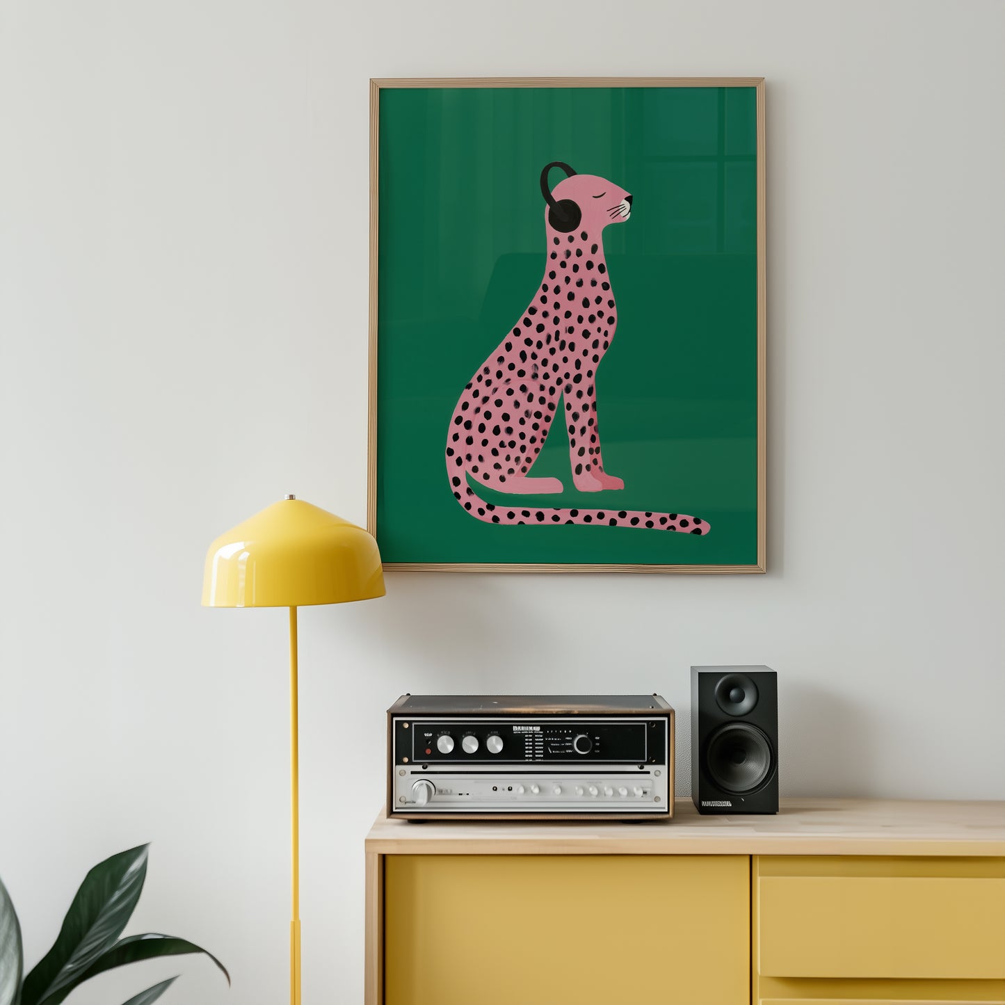 organic luxe artwork of a pink cheetah with headphones on a green background, above a yellow cabinet with stereo equipment.