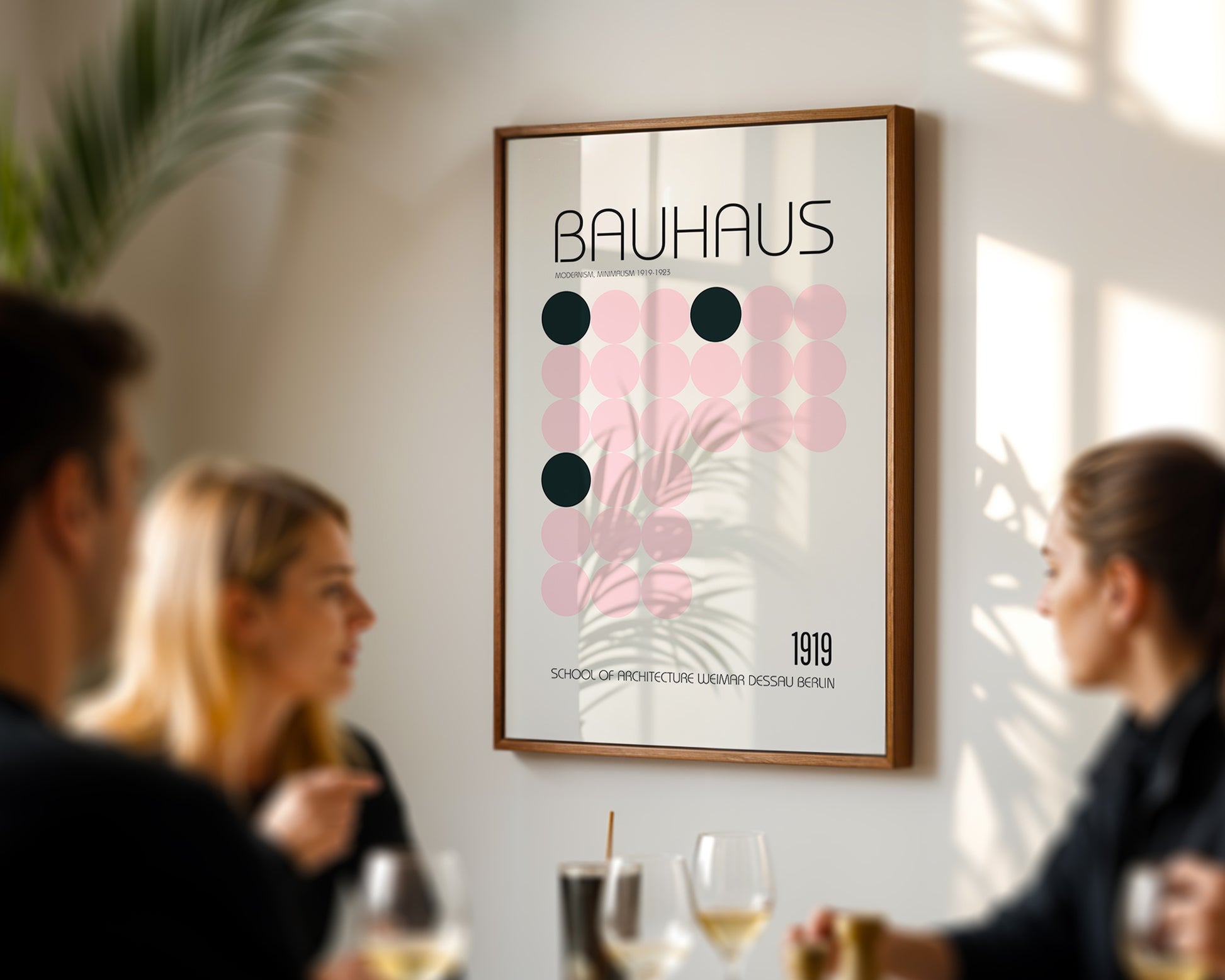 Framed Bauhaus poster in a modern interior setting with people socializing.