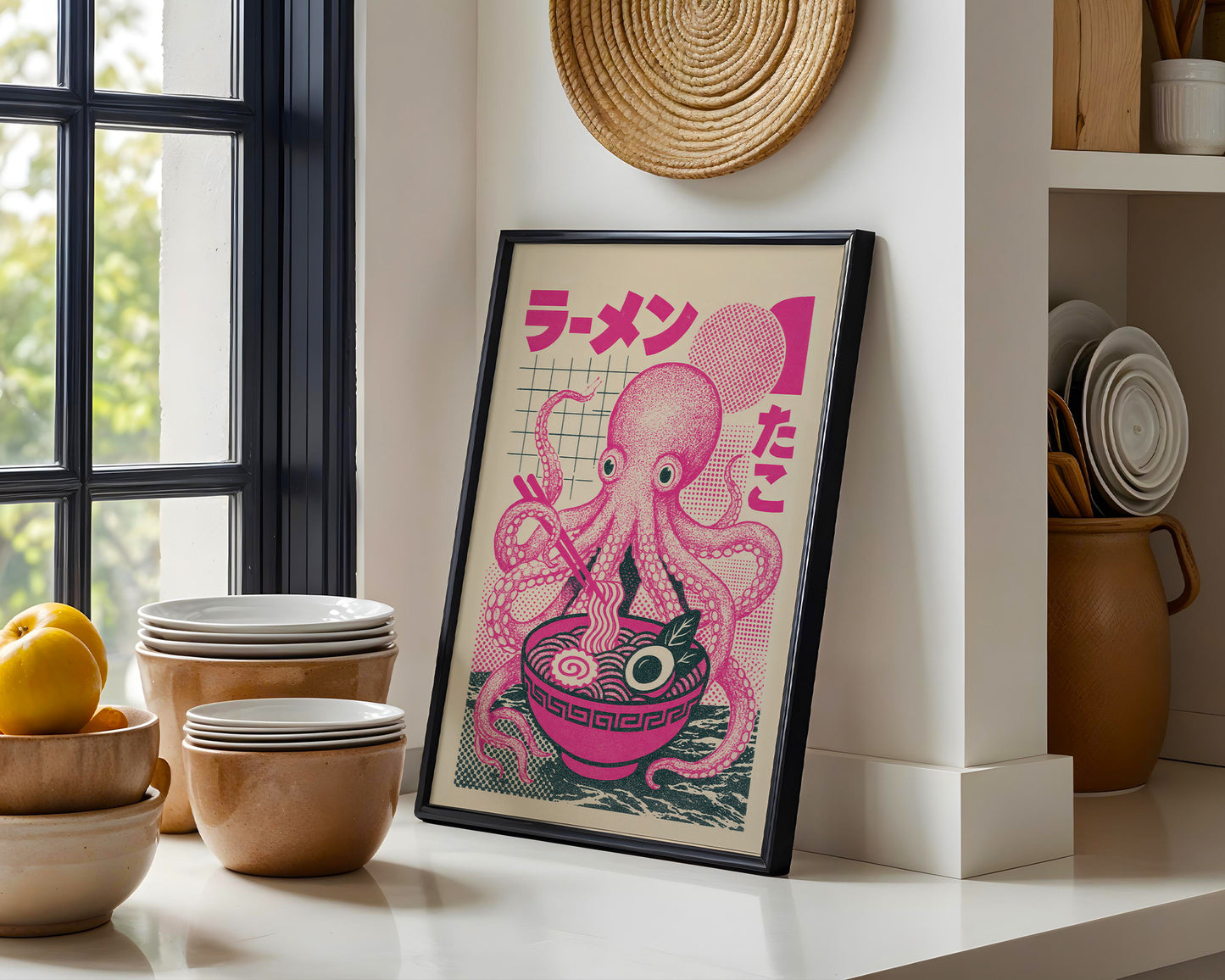 Framed artwork of an octopus with Japanese text on a kitchen counter.