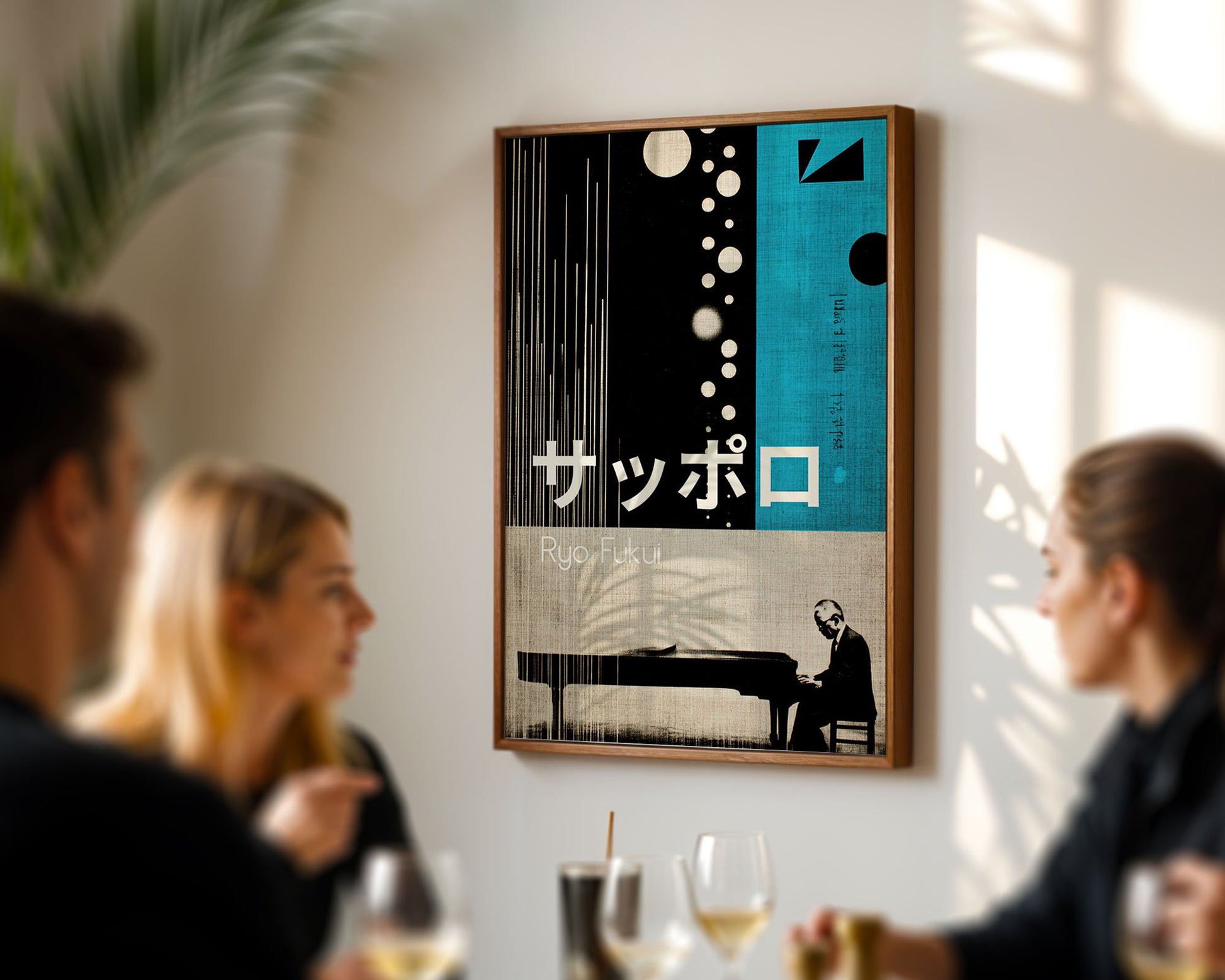 Framed artwork with a piano and text on a wall in a room with people.