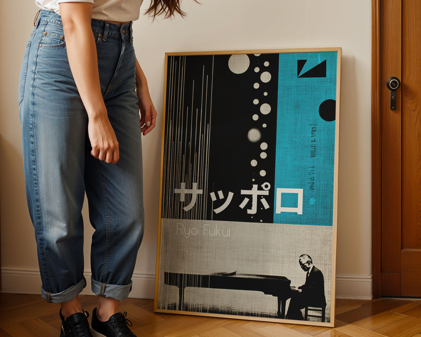 Person standing next to a framed poster on a wall