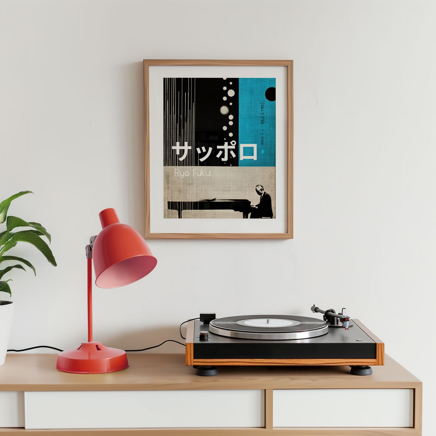 Turntable on a wooden shelf with a red lamp and framed poster on a white wall.