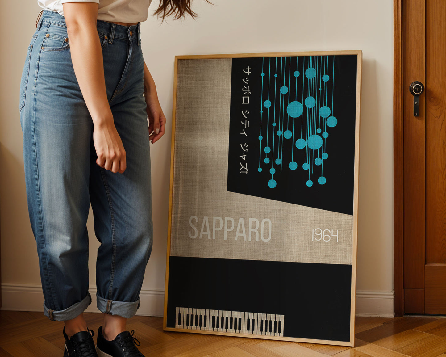 Person standing next to a framed poster with 'Sapporo 1964' design on a wall.