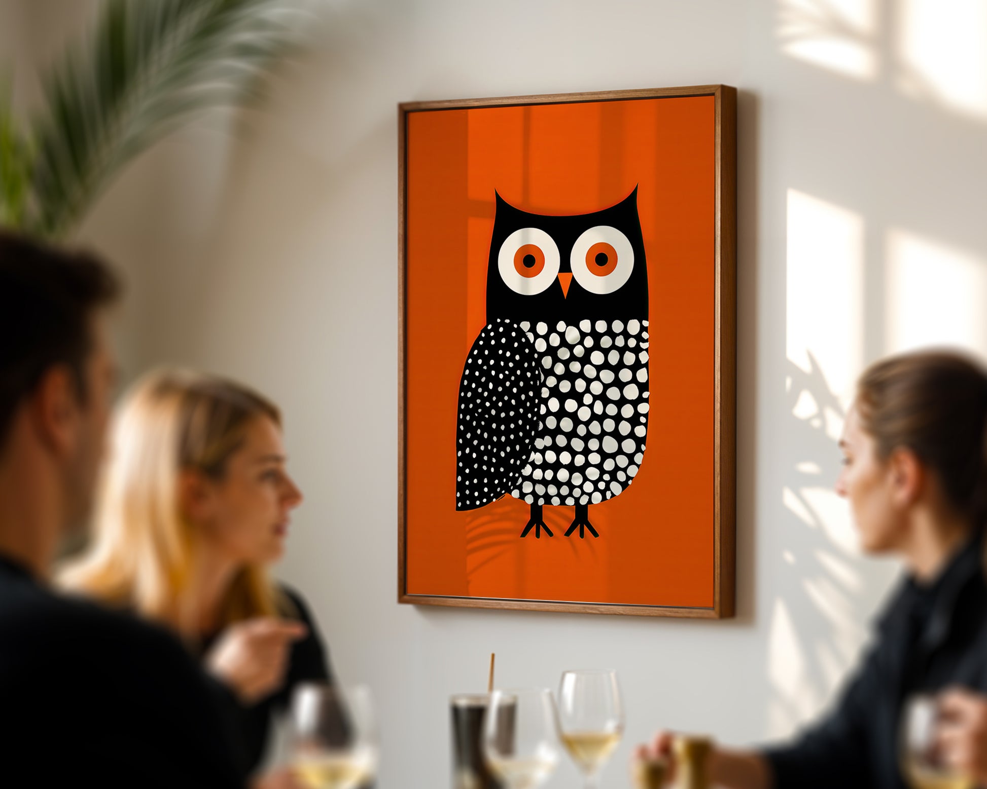 owl print illustration in a Nordic style interior ,ina dining room with people sat round a table. 