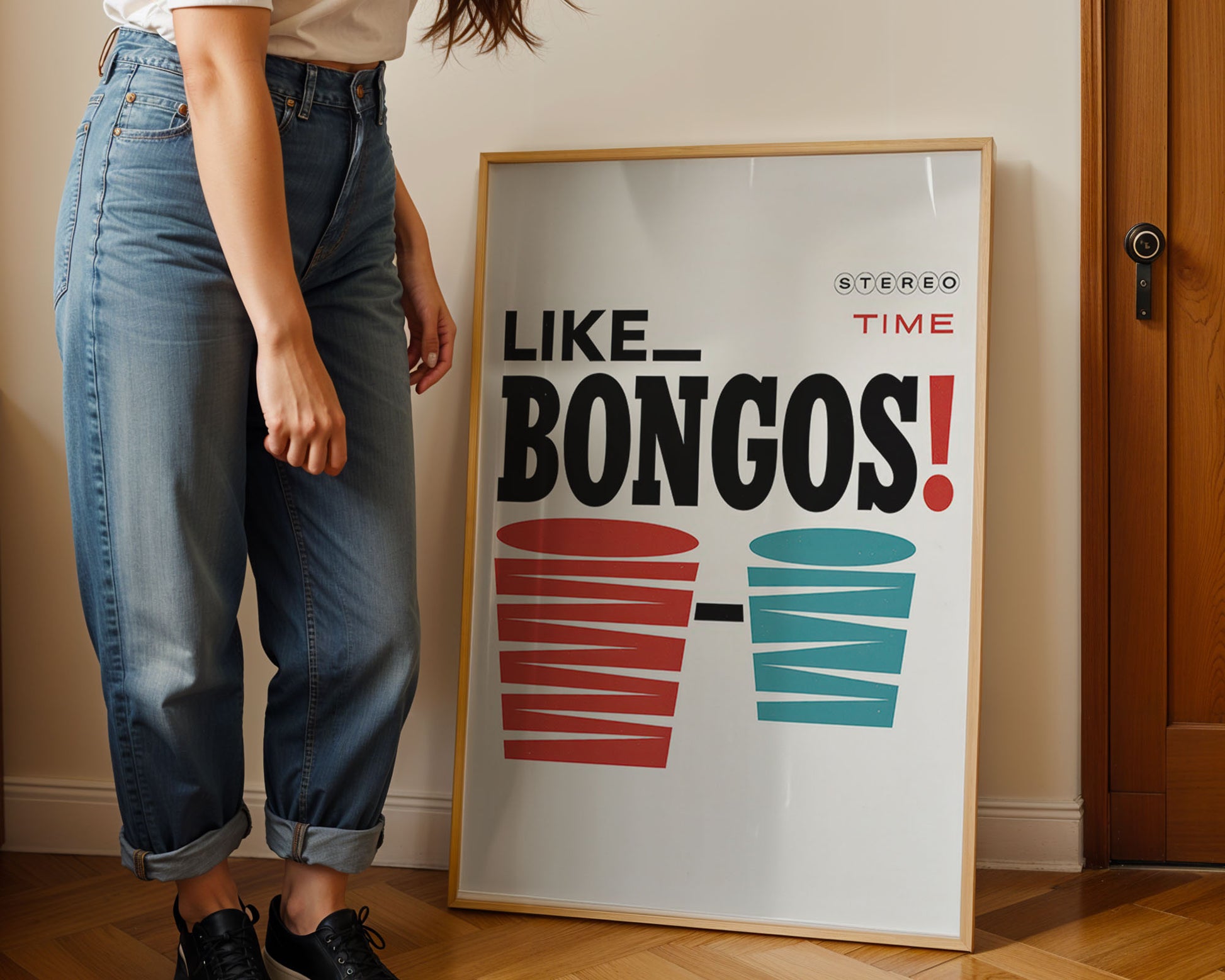 Person standing next to a framed poster with 'LIKE BONGOS!' text and cup graphics.