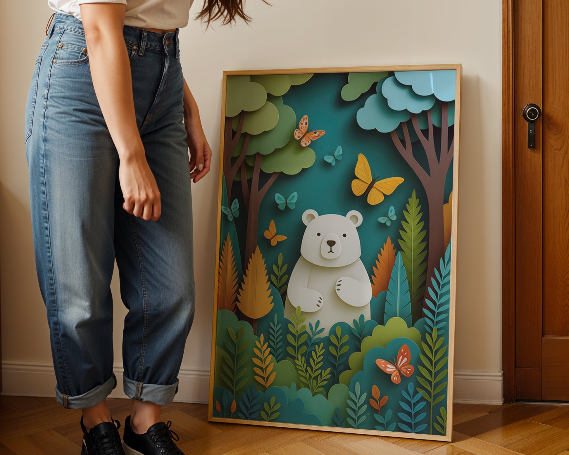 Person standing next to a colorful framed artwork of a bear in a forest.
