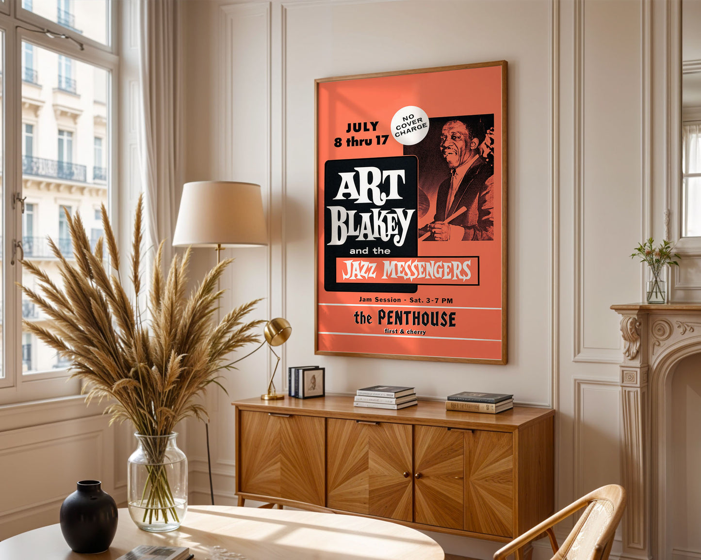 Living room with a framed poster of Art Blakey and the Jazz Messengers, wooden cabinet, and decorative items.