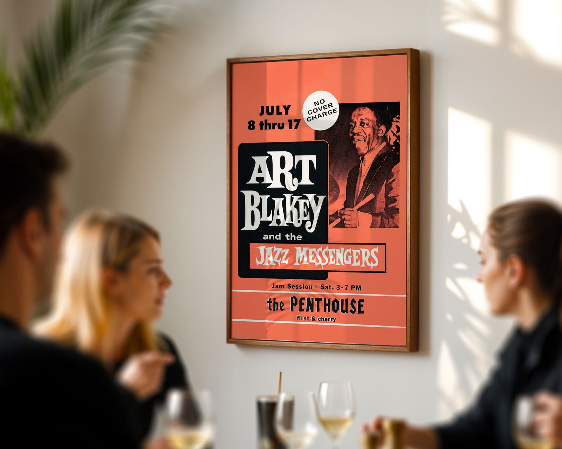 Framed poster of Art Blakey and the Jazz Messengers on a wall in a social setting.