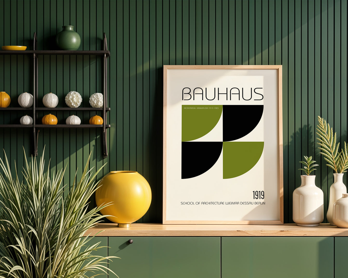 Framed Bauhaus poster on a wooden shelf with decorative items against a green wall.