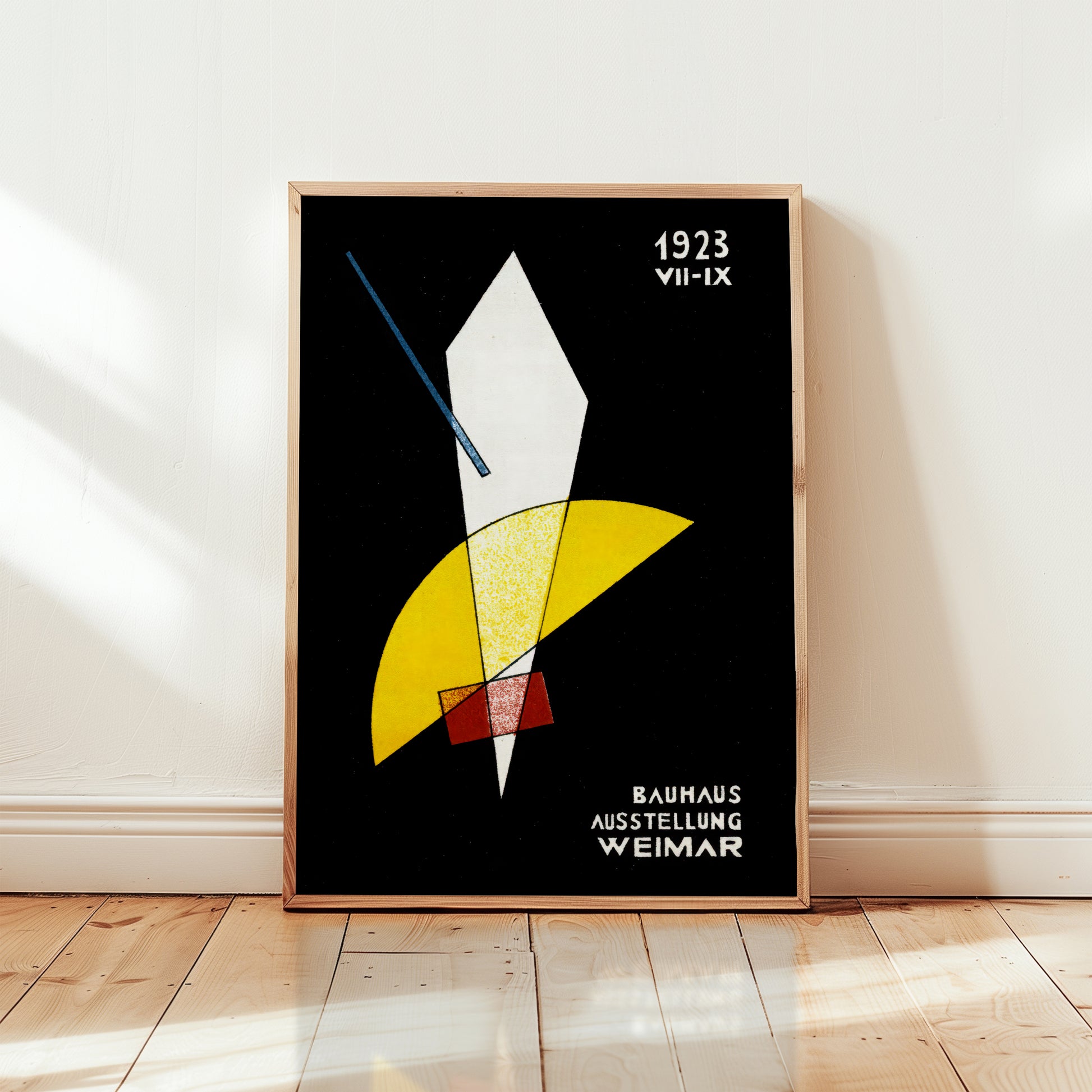 Framed bauhaus poster abstract art print with geometric shapes on a black background, displayed on a wall.