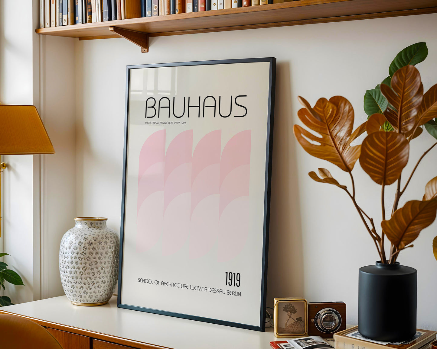 Framed Bauhaus poster on a shelf with decorative items