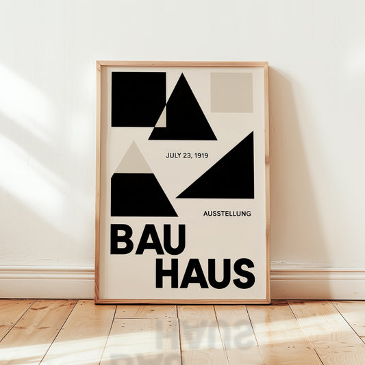 Framed Bauhaus poster with geometric design and text on a wall.
