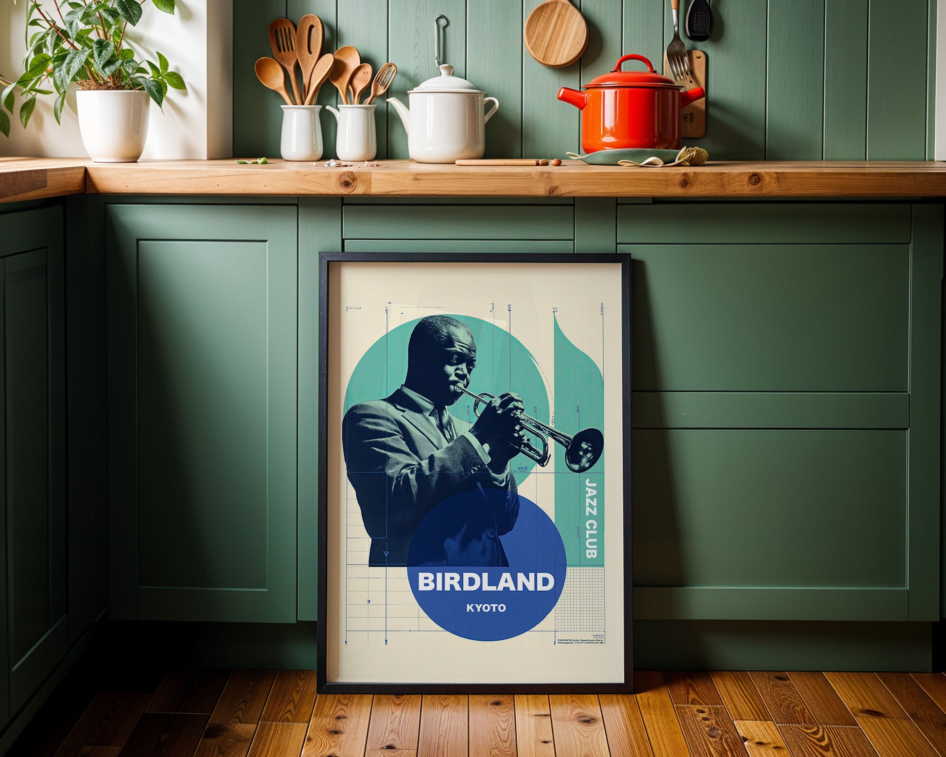 Framed poster of a jazz musician playing a trumpet on a kitchen wall.