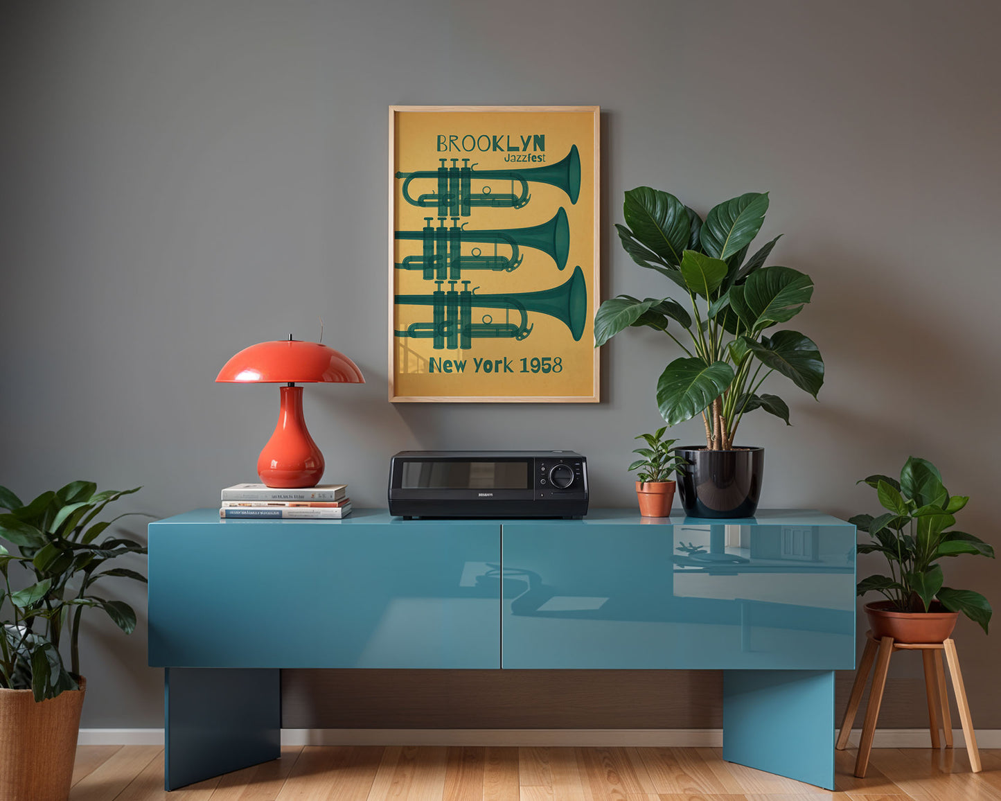 Modern interior with a blue console table, red lamp, and framed poster on a gray wall.